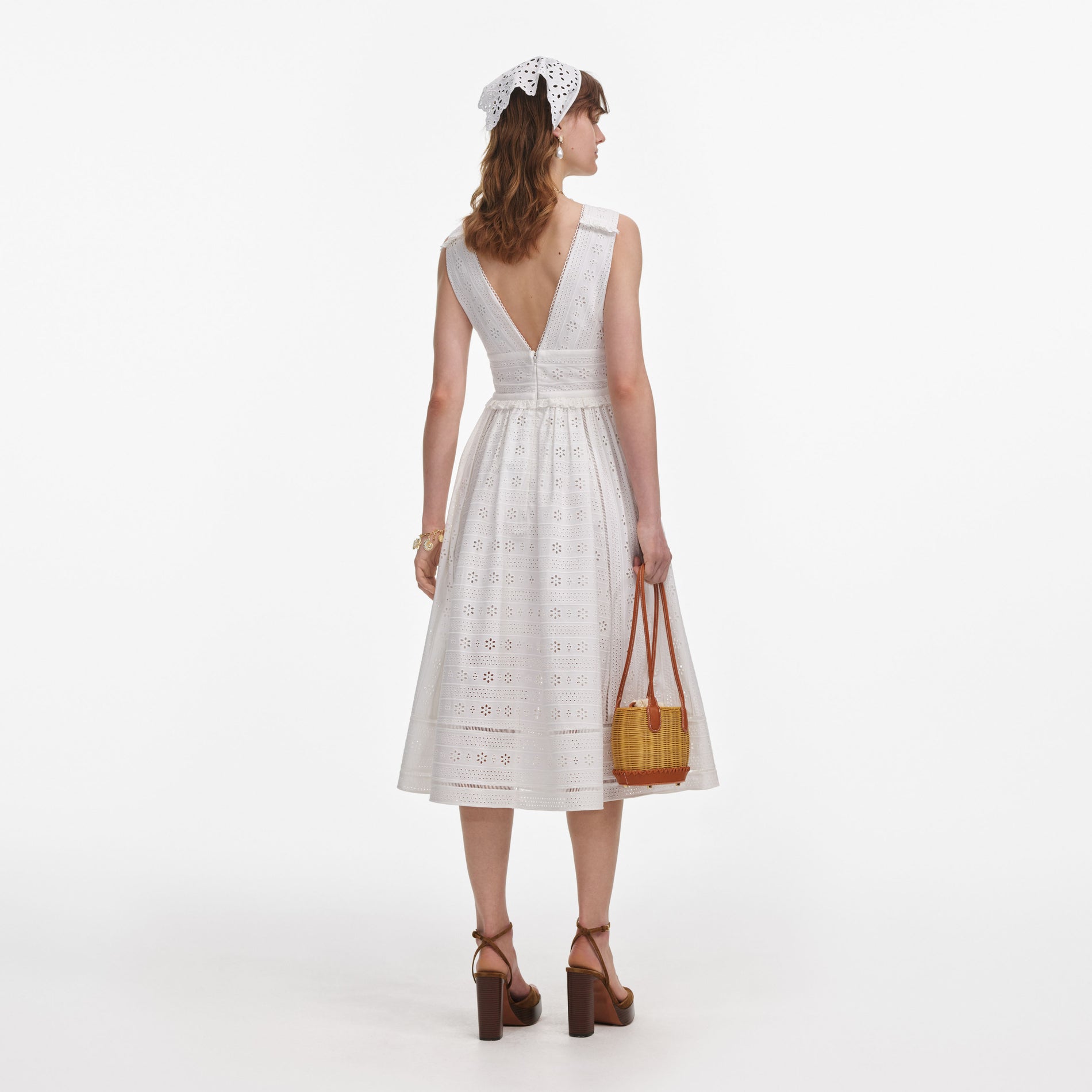 Back view of a woman wearing the White Cotton Broderie Midi Dress