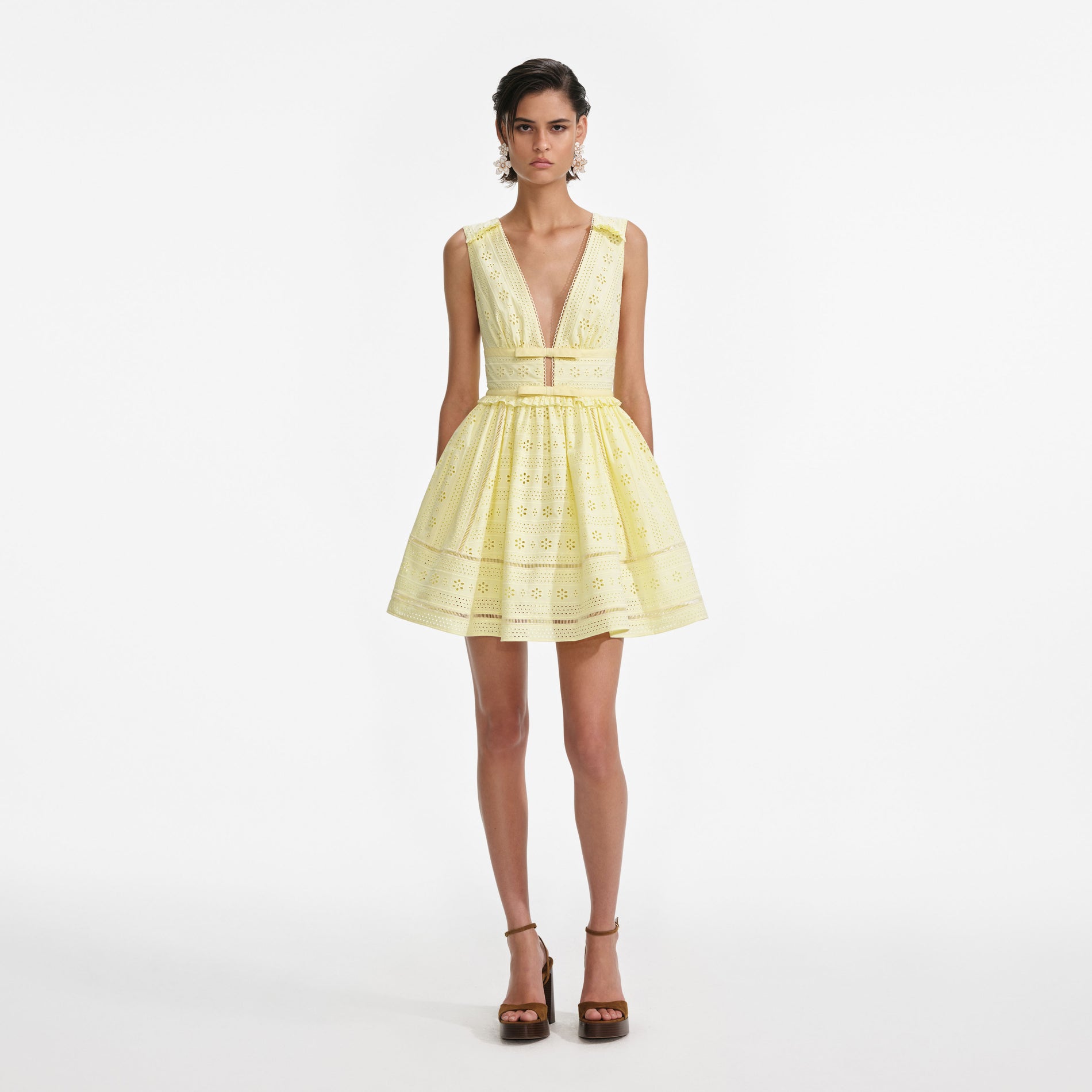 Front view of a woman wearing the Yellow Cotton Broderie Mini Dress