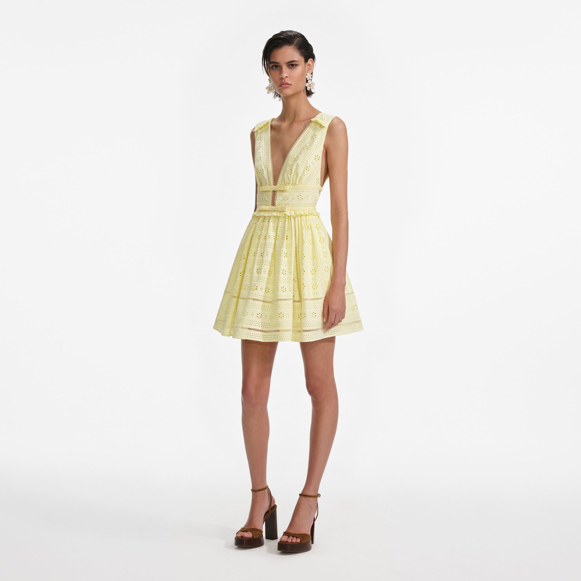 Side view of a woman wearing the Yellow Cotton Broderie Mini Dress
