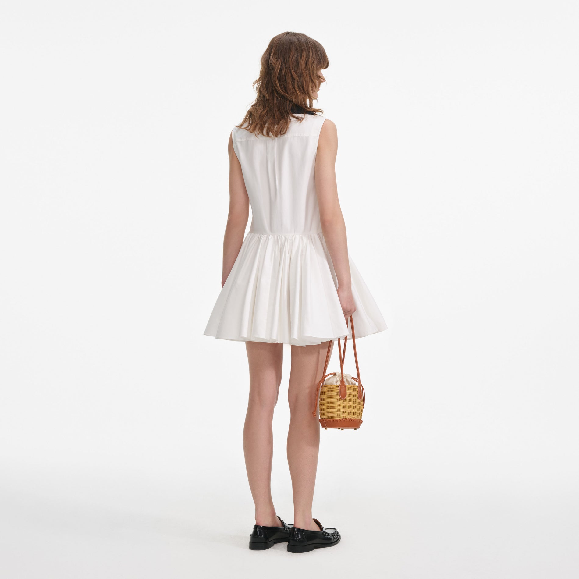 Back view of a woman wearing the White Cotton Contrast Collar Mini Dress