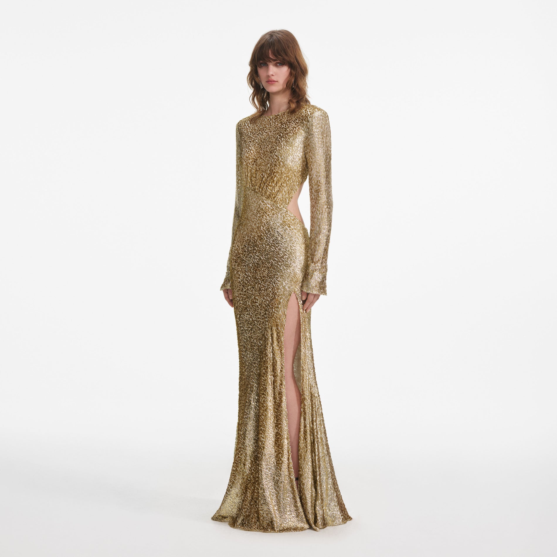 Side view of a woman wearing the Gold Fil Coupe Maxi Dress