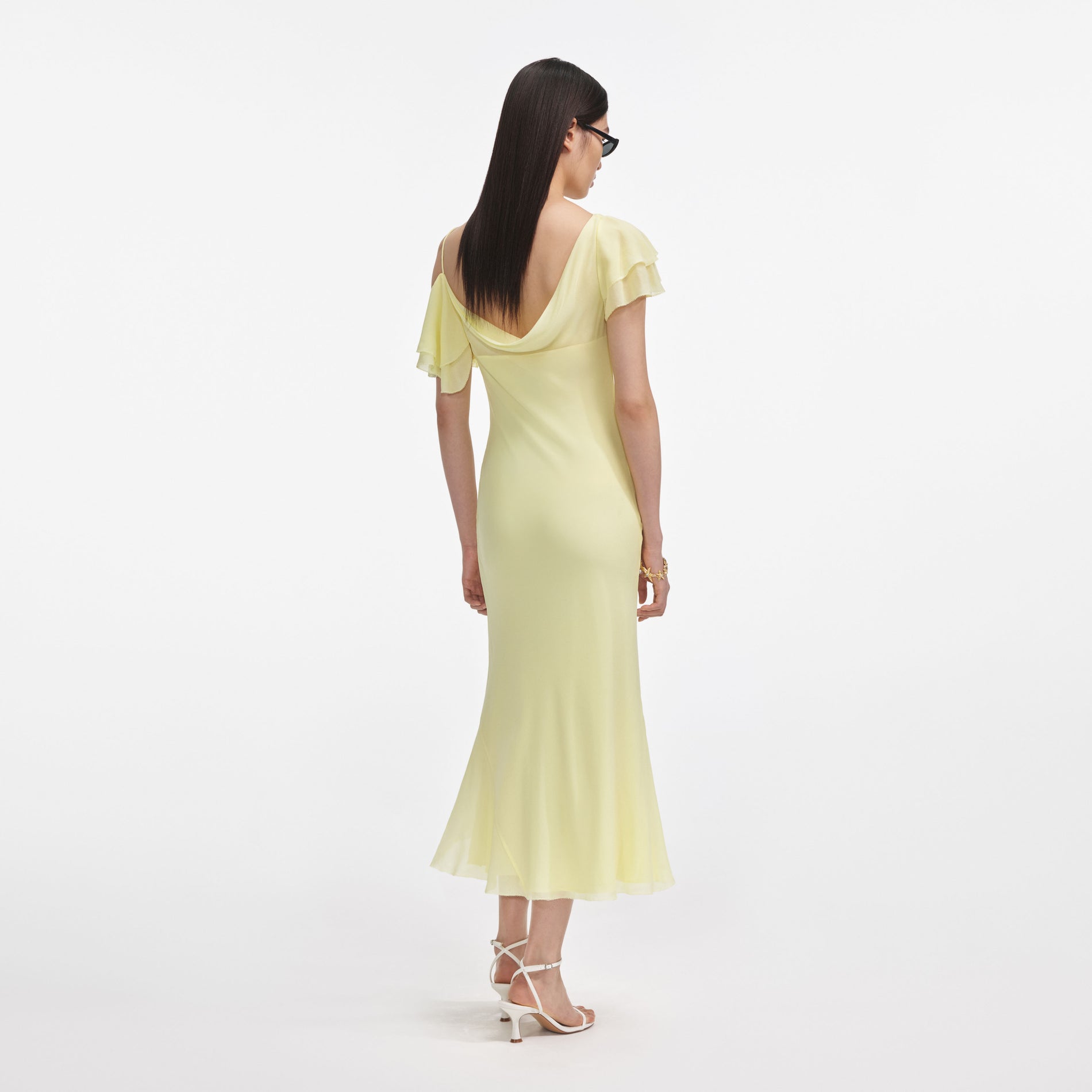 Back view of a woman wearing the Yellow Georgette Frill Midi Dress