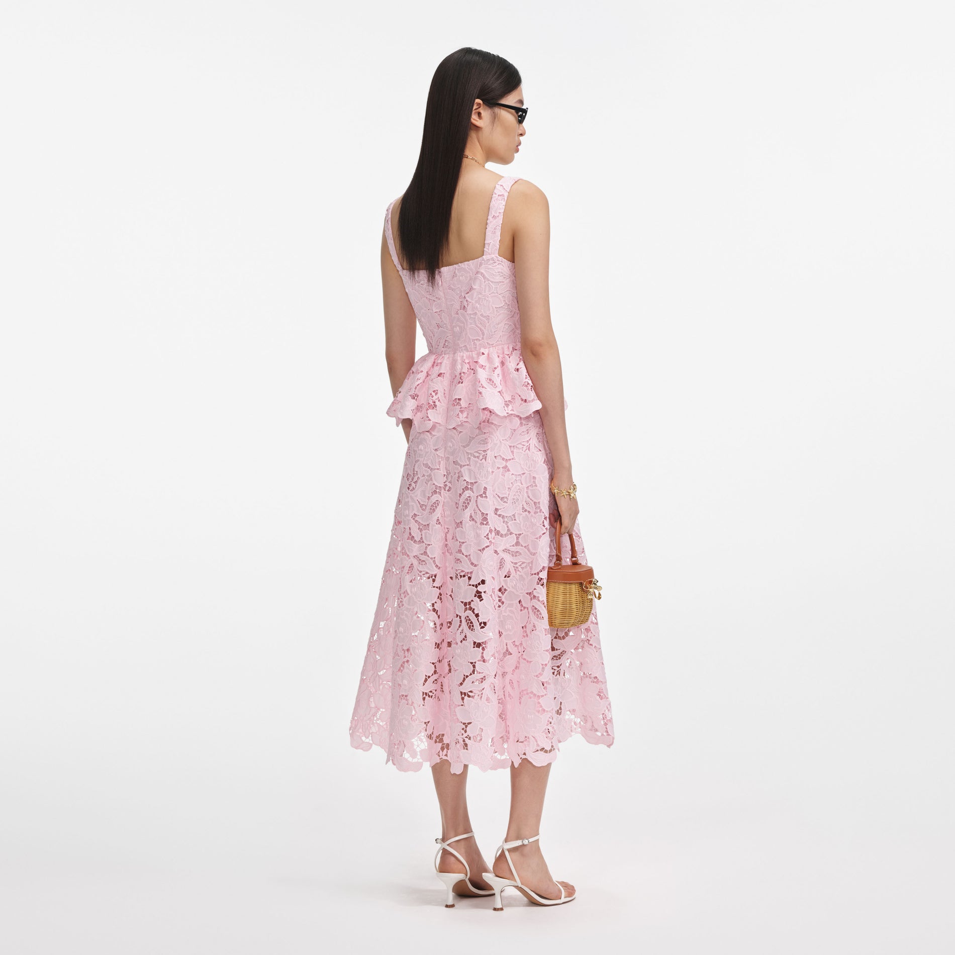Back view of a woman wearing the Pink Lace Peplum Midi Dress