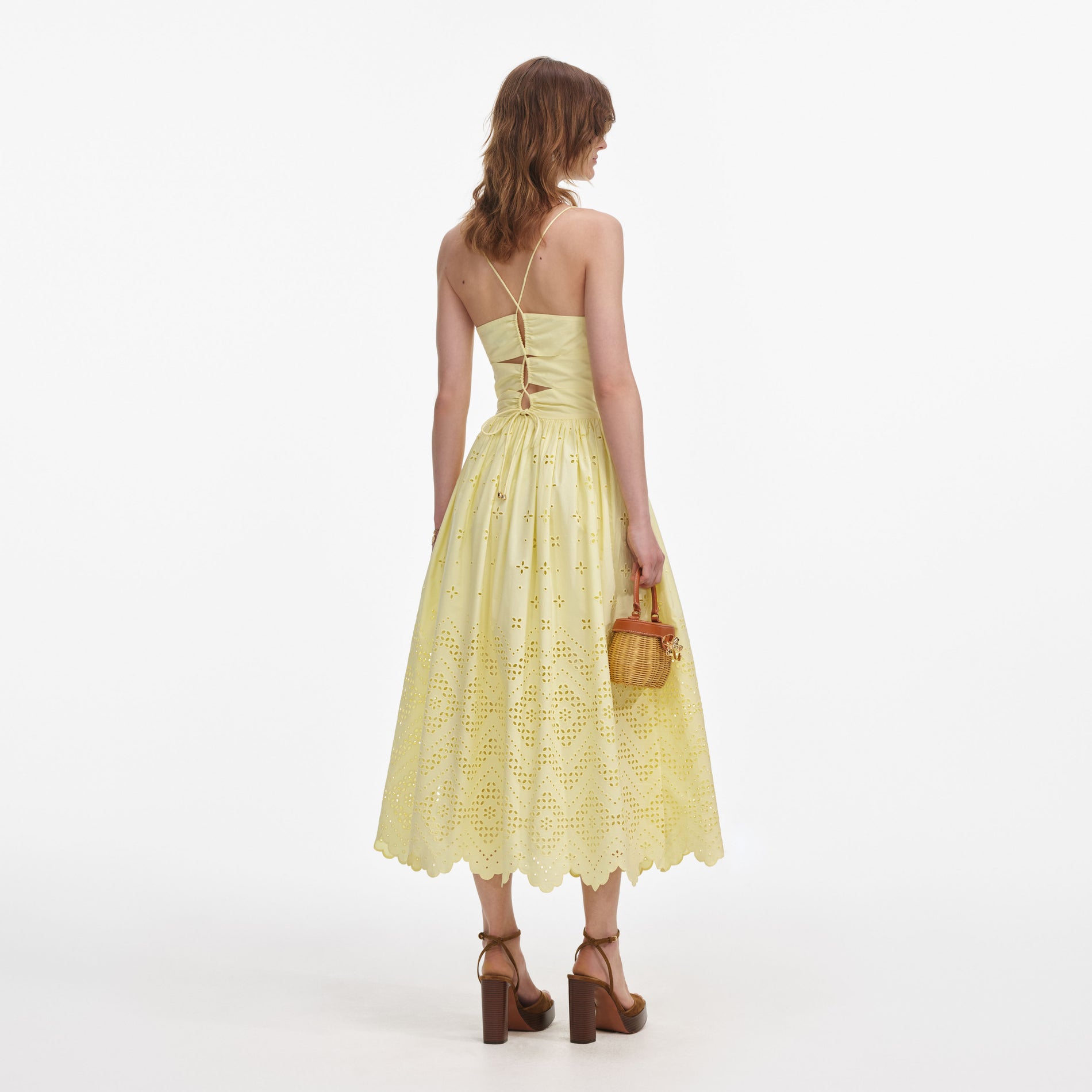 Back view of a woman wearing the Yellow Cotton Broderie Midi Dress