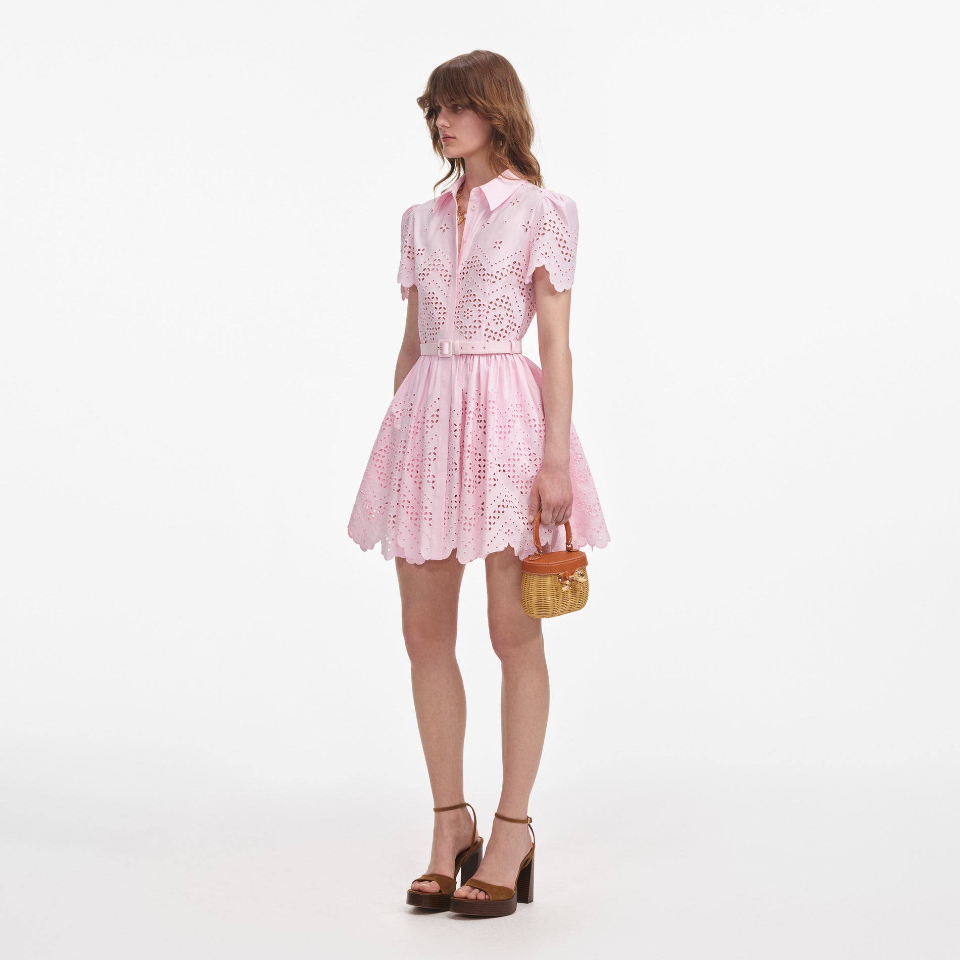 Side view of a woman wearing the Pink Cotton Broderie Mini Dress