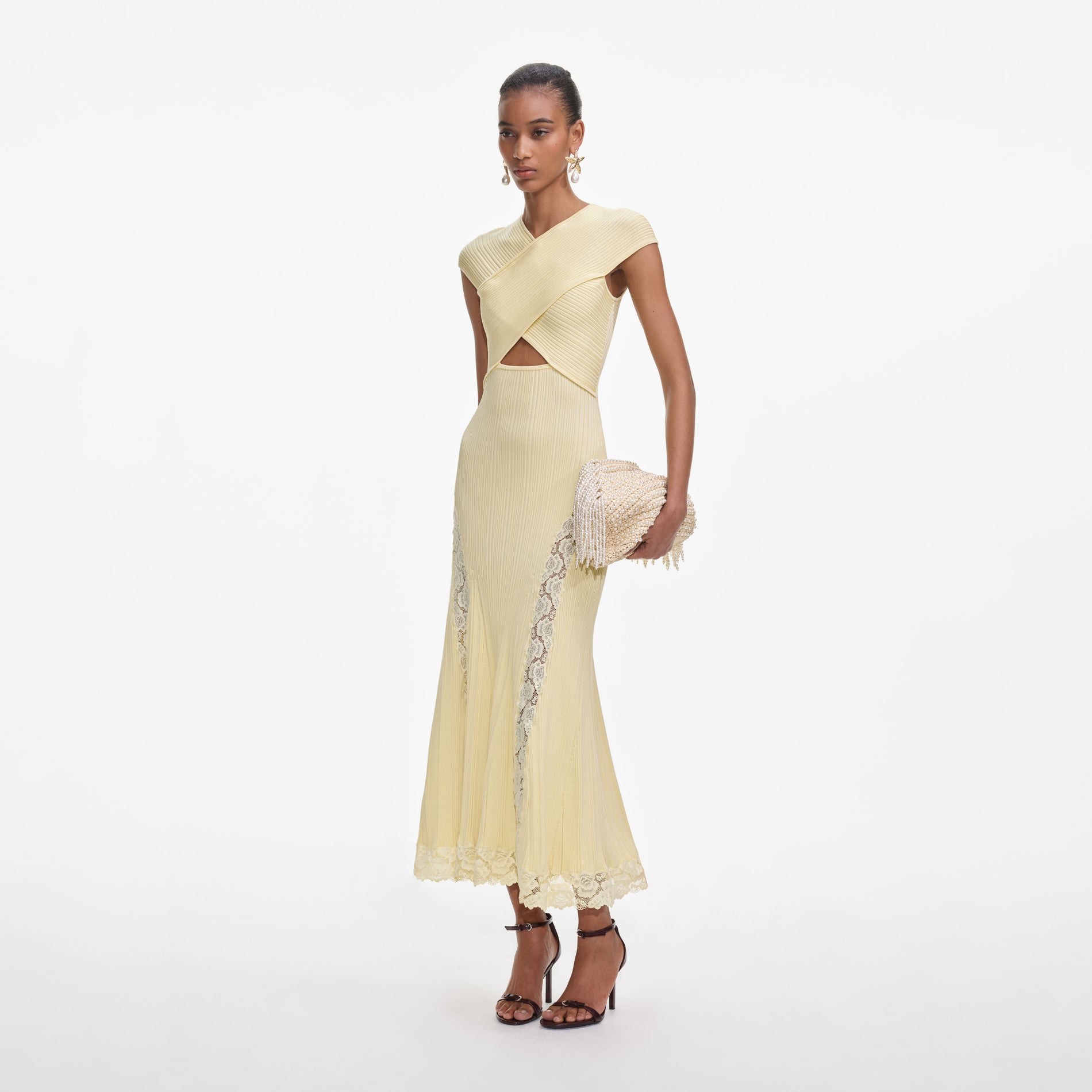 Side view of a woman wearing the Yellow Knit Lace Insert Midi Dress