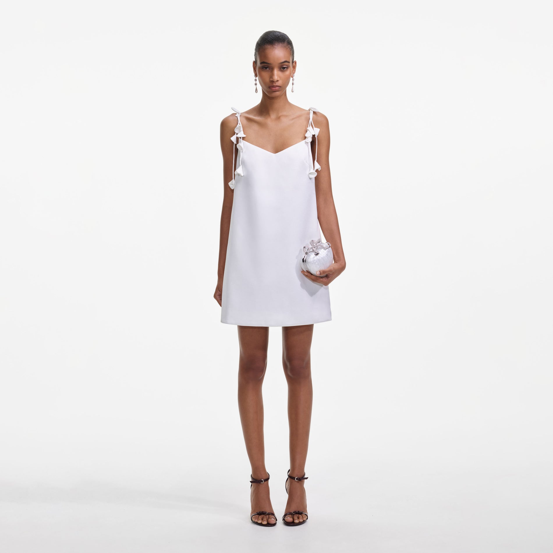 Front view of a woman wearing the White Satin Flower Mini Dress