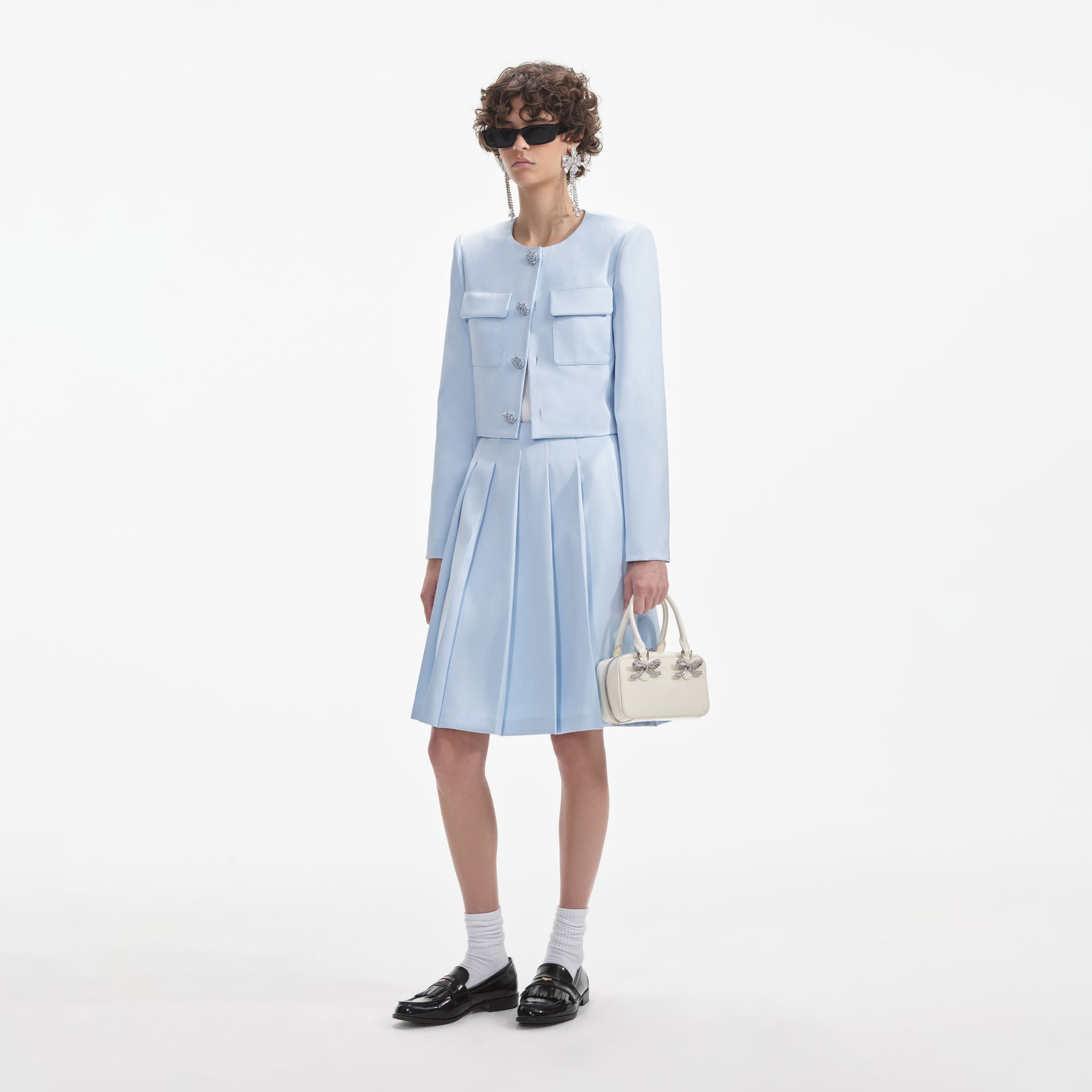 Side view of a woman wearing the Blue Satin Jacket