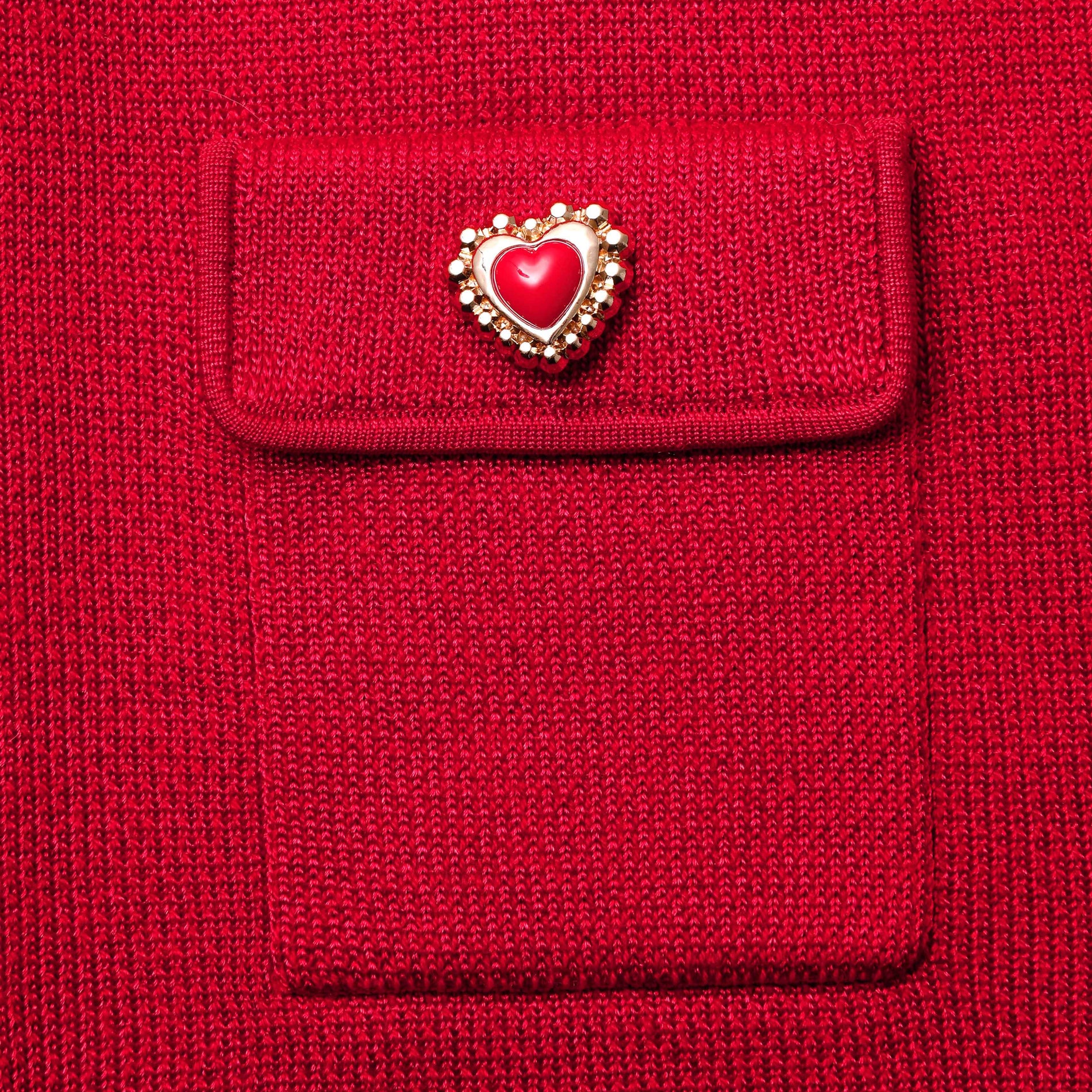 A close up of the fabric for the Red Knit Heart Buttoned Midi Skirt