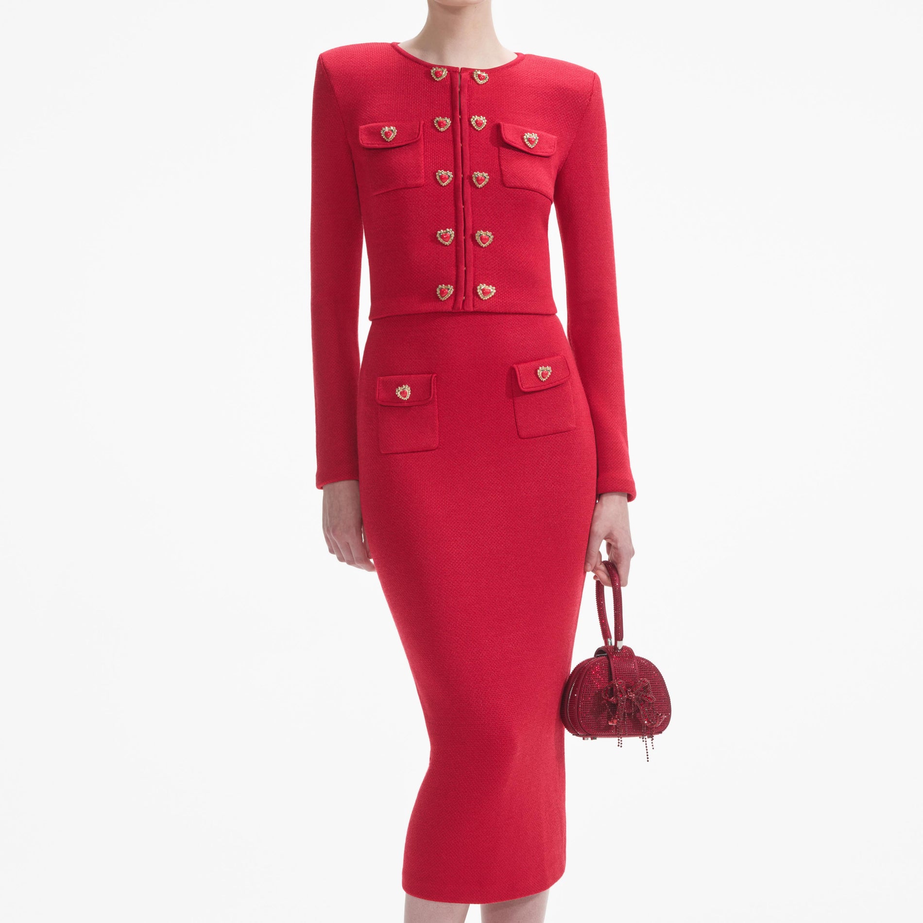 A close up of a woman wearing the Red Knit Heart Buttoned Midi Skirt