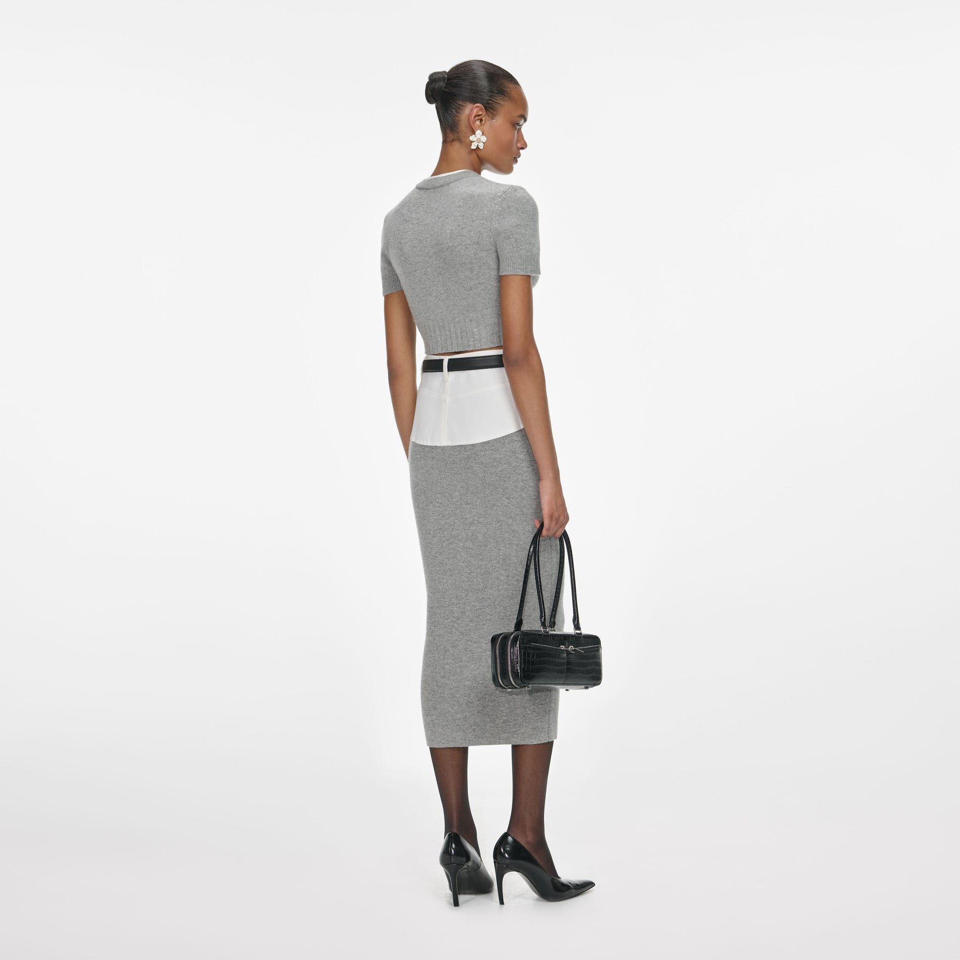Back view of a woman wearing the Grey Short Sleeve Knit Top