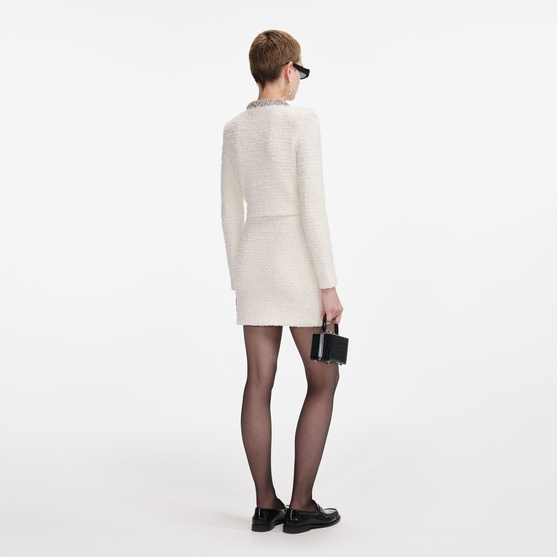 Back view of a woman wearing the Cream Textured Knit Cardigan