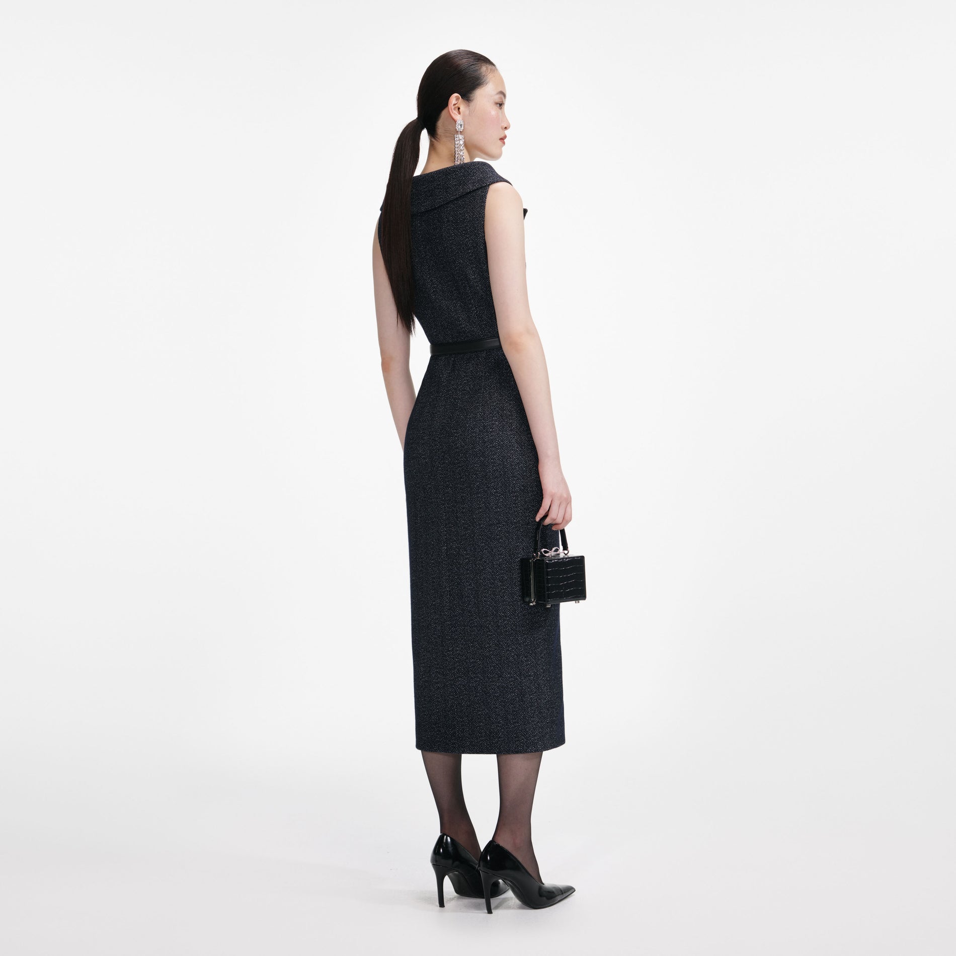 Back view of a woman wearing the Navy Herringbone Wool Midi Dress