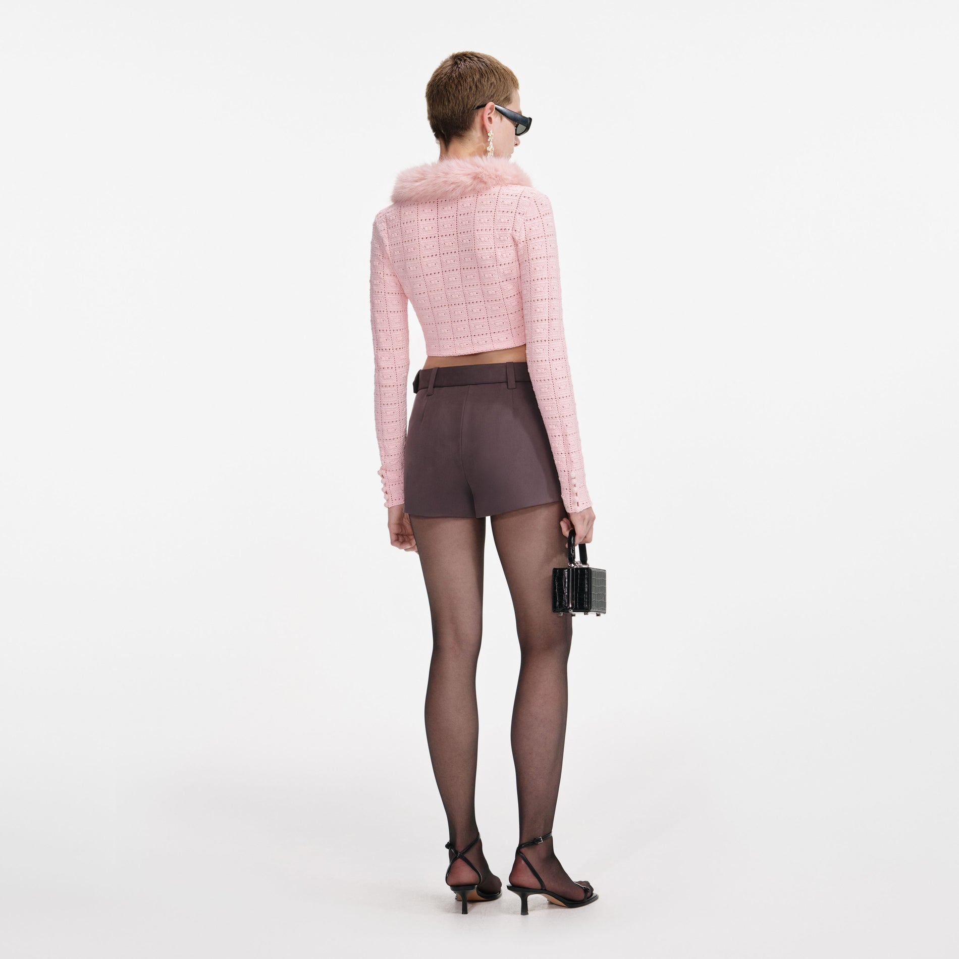 Back view of a woman wearing the Pink Fur Collar Cardigan
