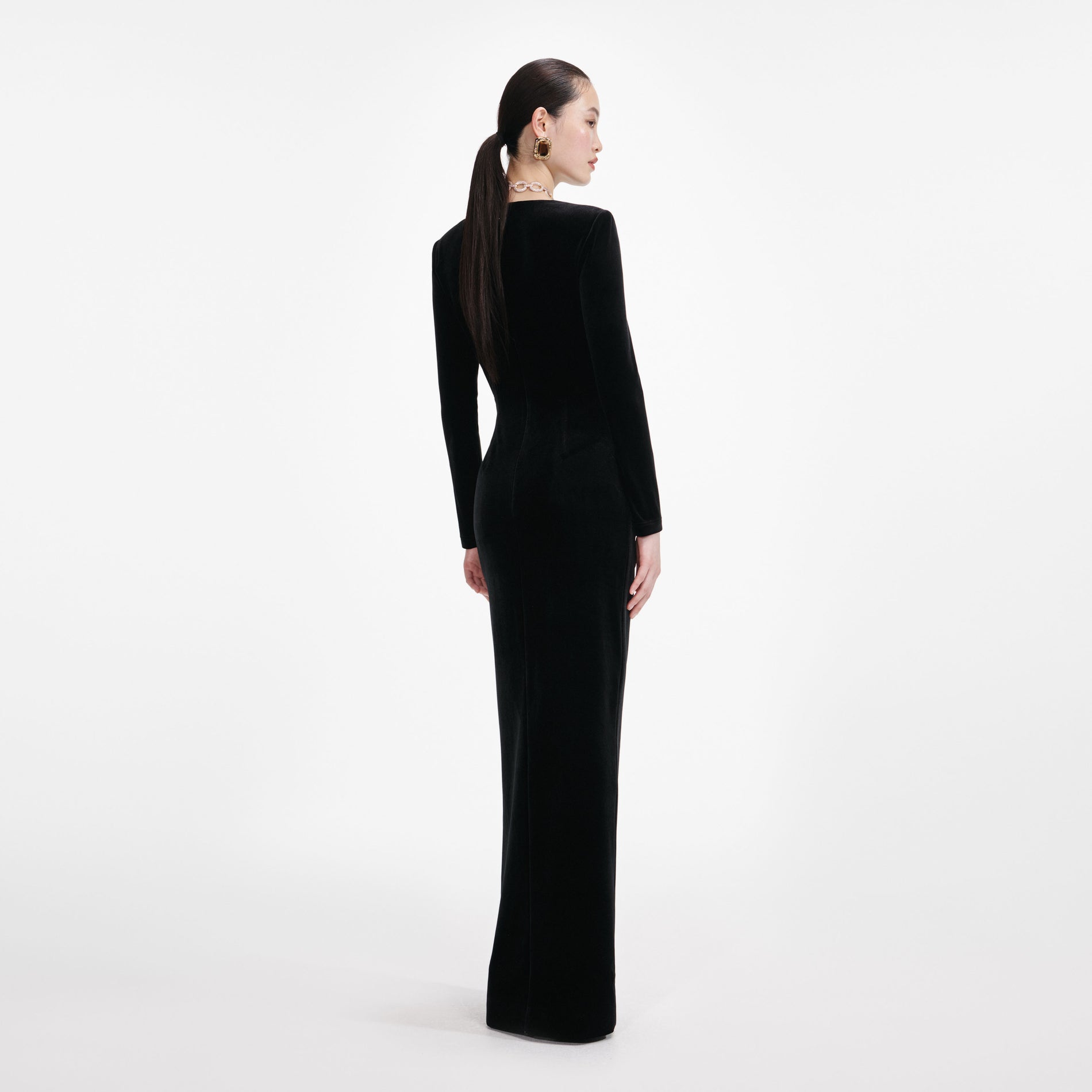 Back view of a woman wearing the Black Velvet Embellished Maxi Dress