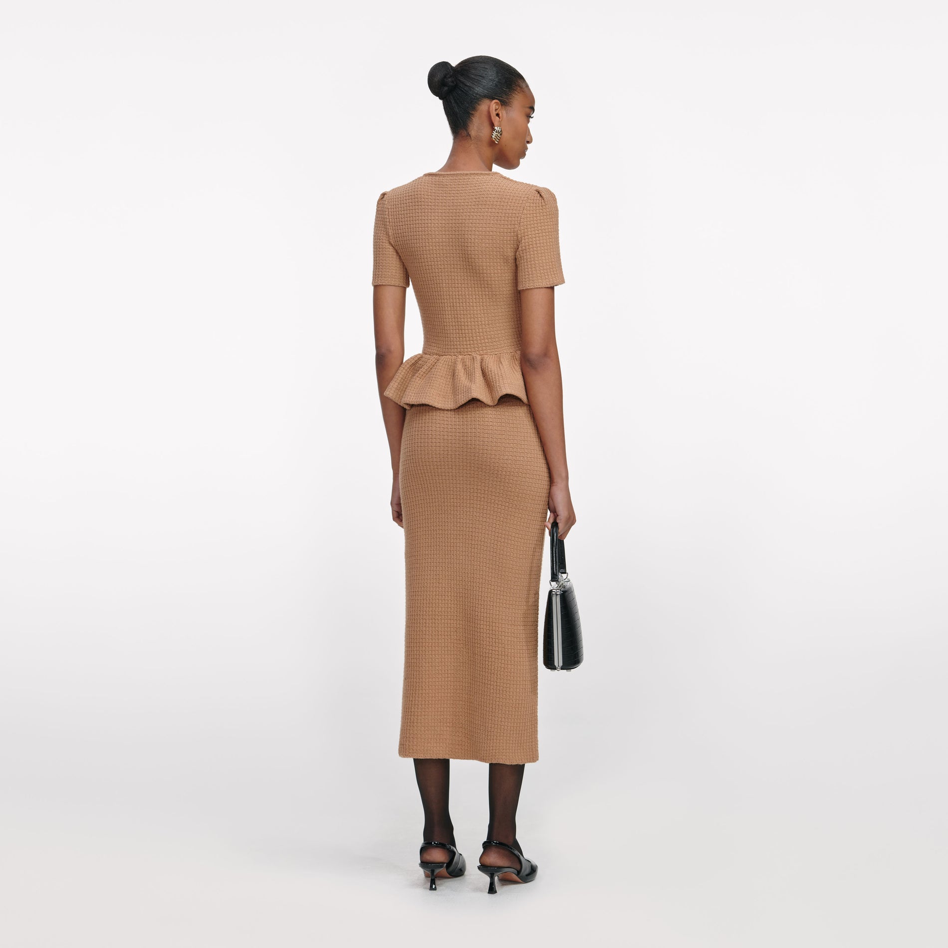 Back view of a woman wearing the Camel Peplum Knit Midi Dress