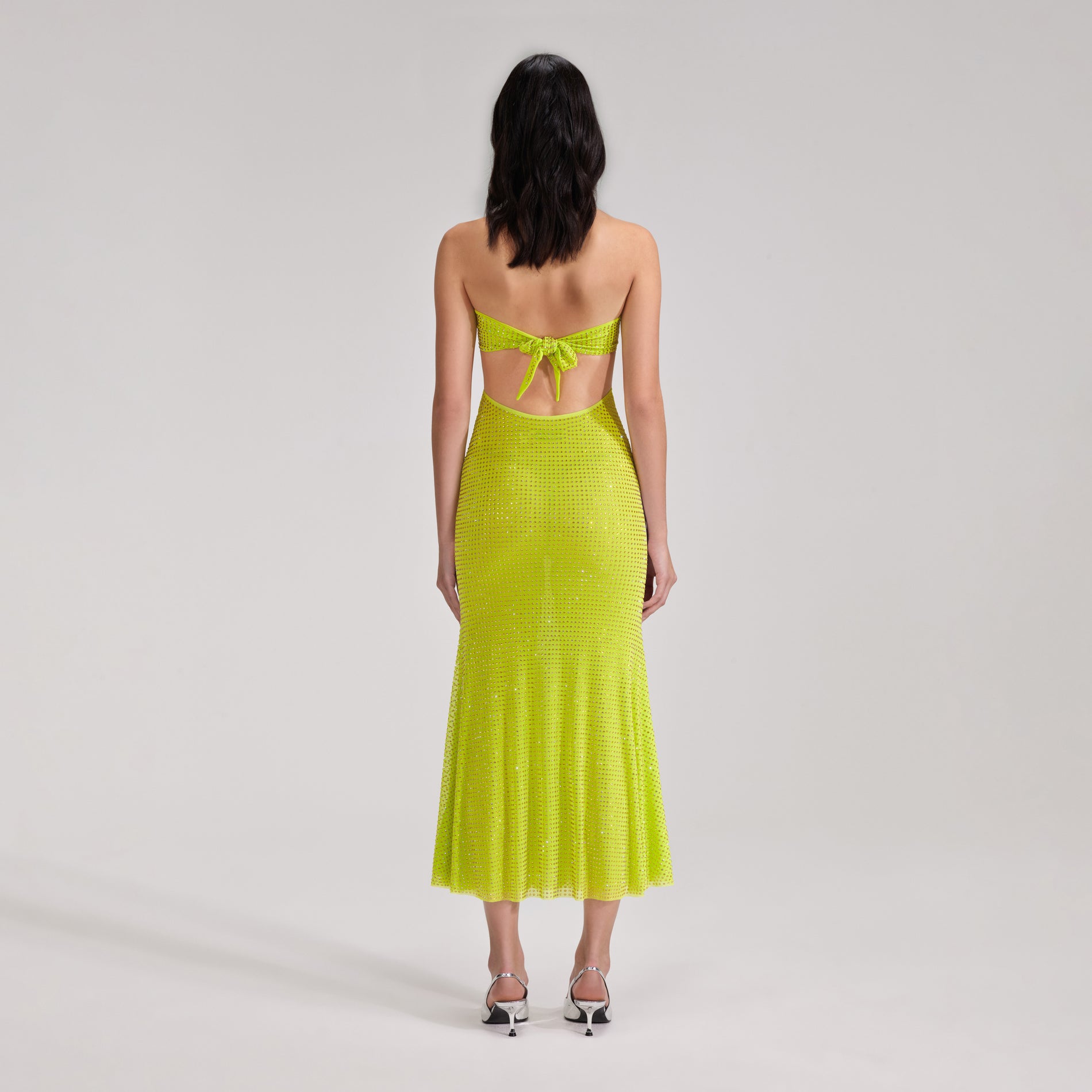 A woman wearing the Green Rhinestone Mesh Midi Dress