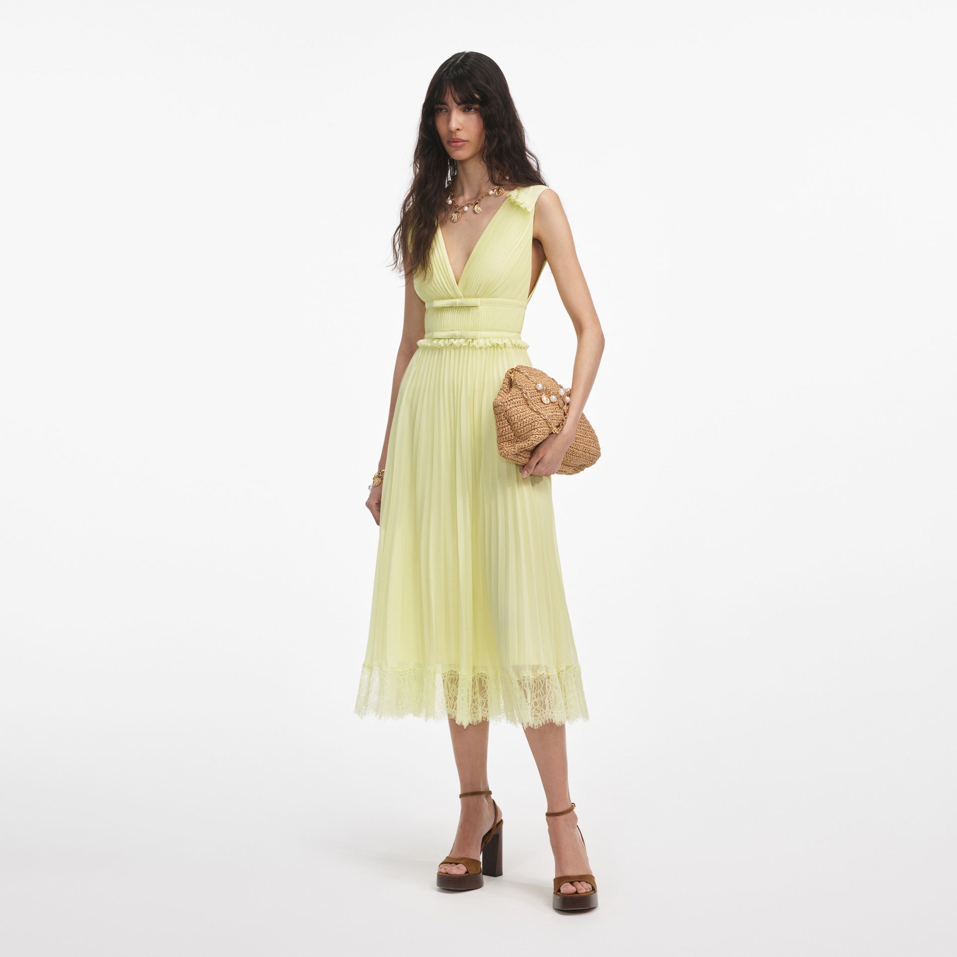 Side view of a woman wearing the Yellow Chiffon Midi Dress
