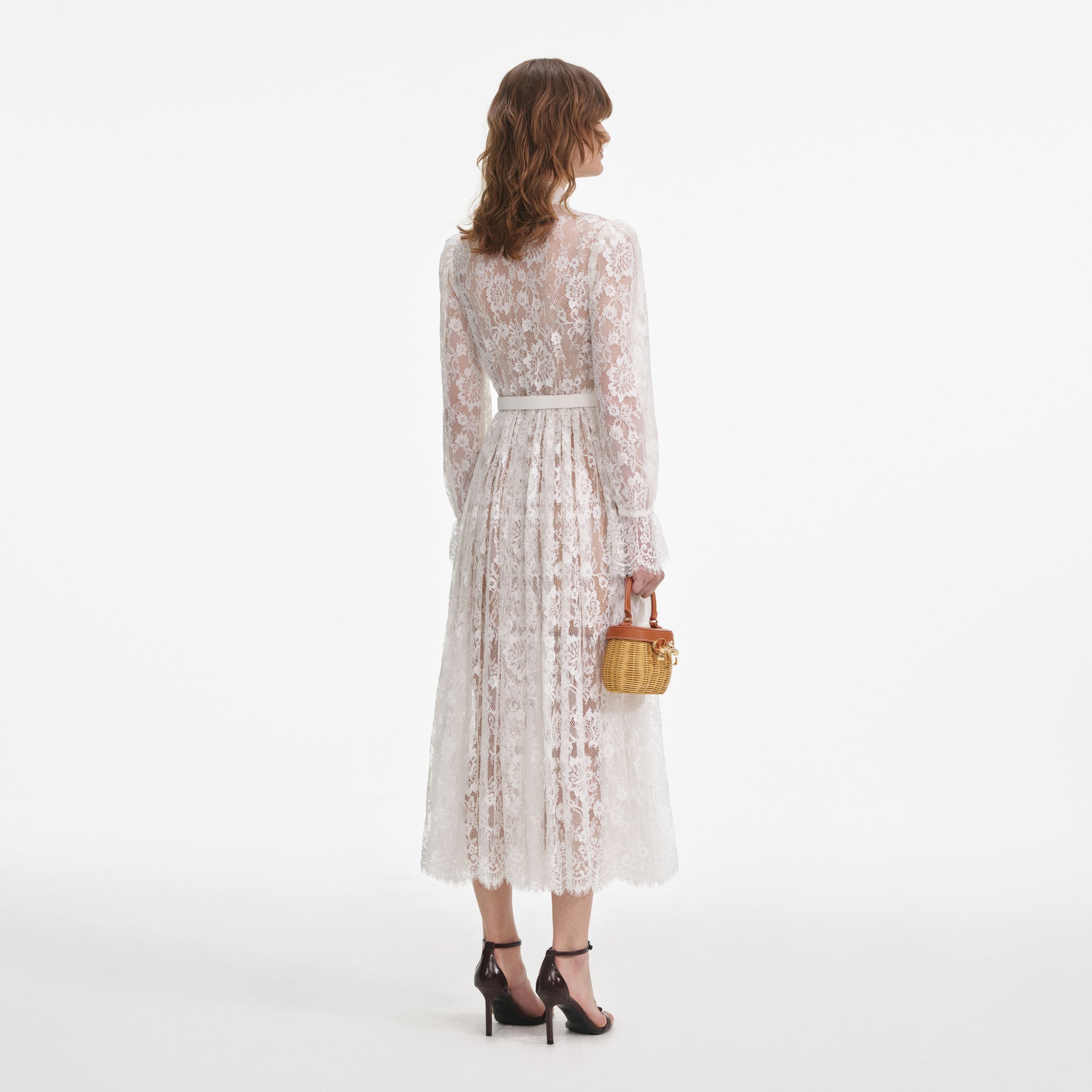 Back view of a woman wearing the White Lace Pussy Bow Midi Dress