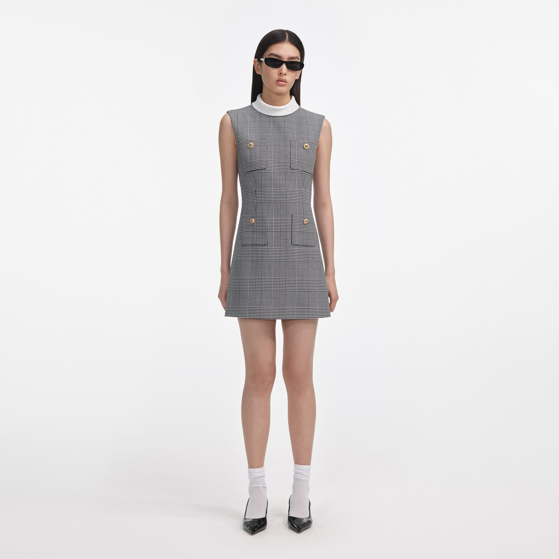 Front view of a woman wearing the Sleeveless Prince Of Wales Check Mini Dress