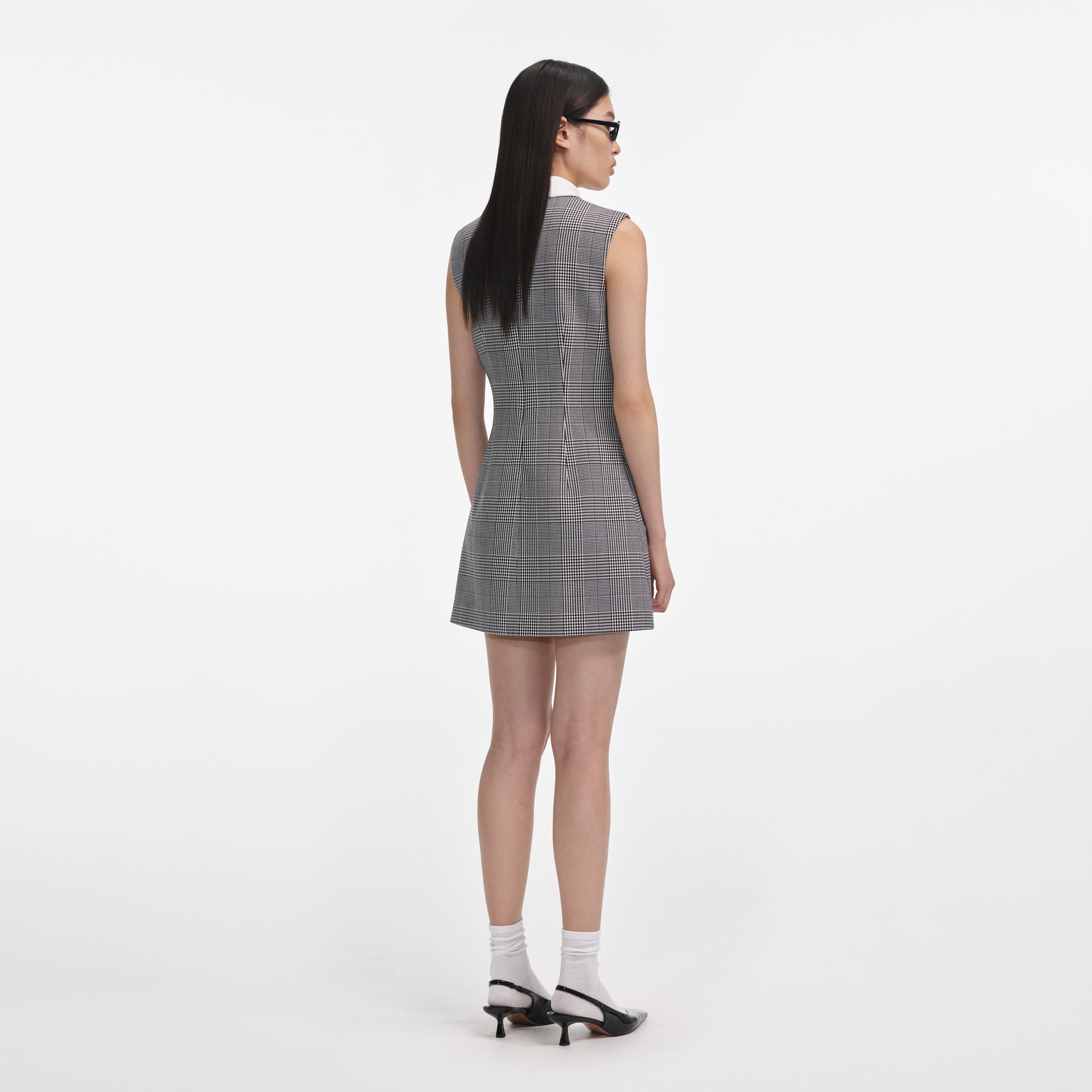 Back view of a woman wearing the Sleeveless Prince Of Wales Check Mini Dress