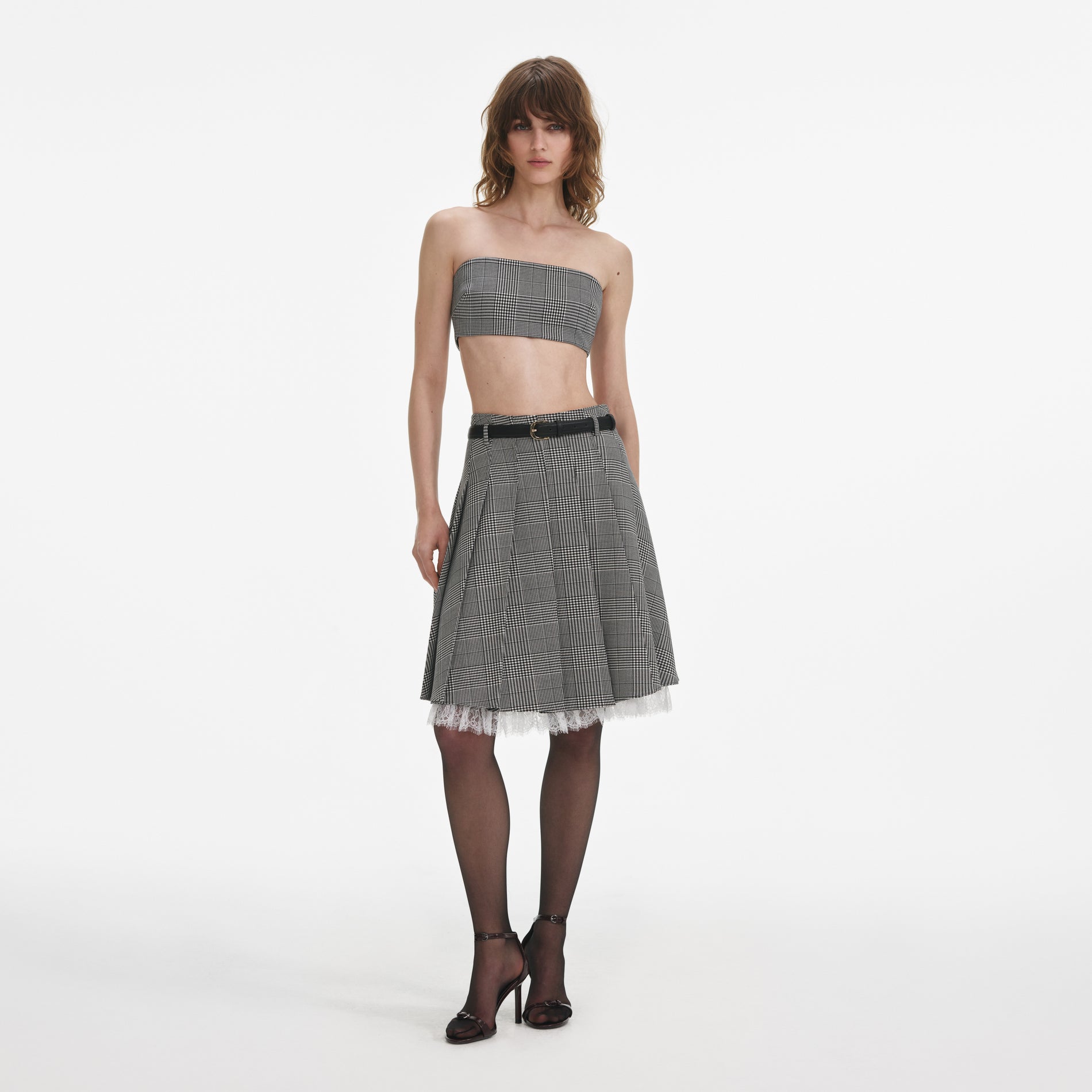 Front view of a woman wearing the Prince Of Wales Check Pleated Midi Skirt
