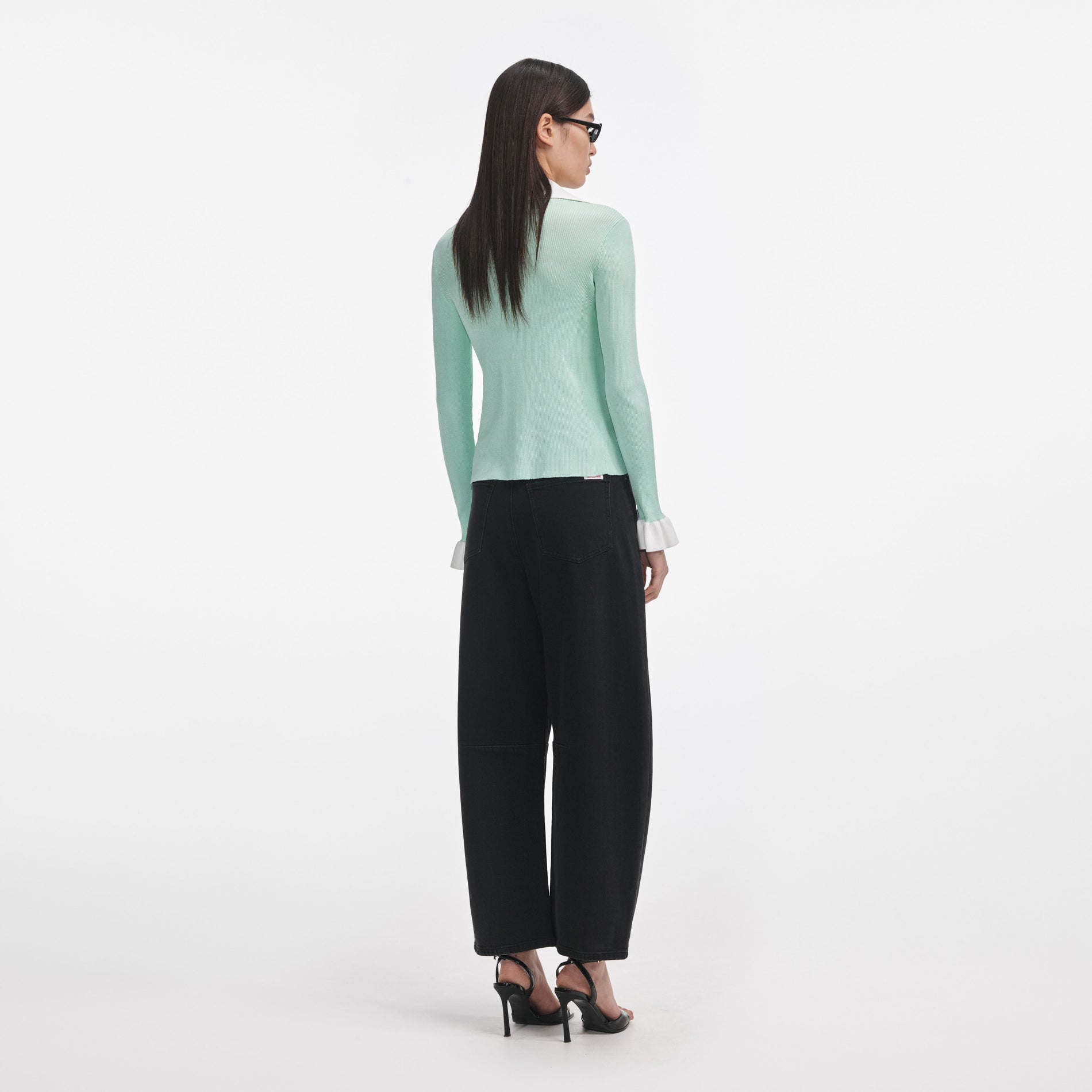 Back view of a woman wearing the Green Ribbed Viscose Knit Top