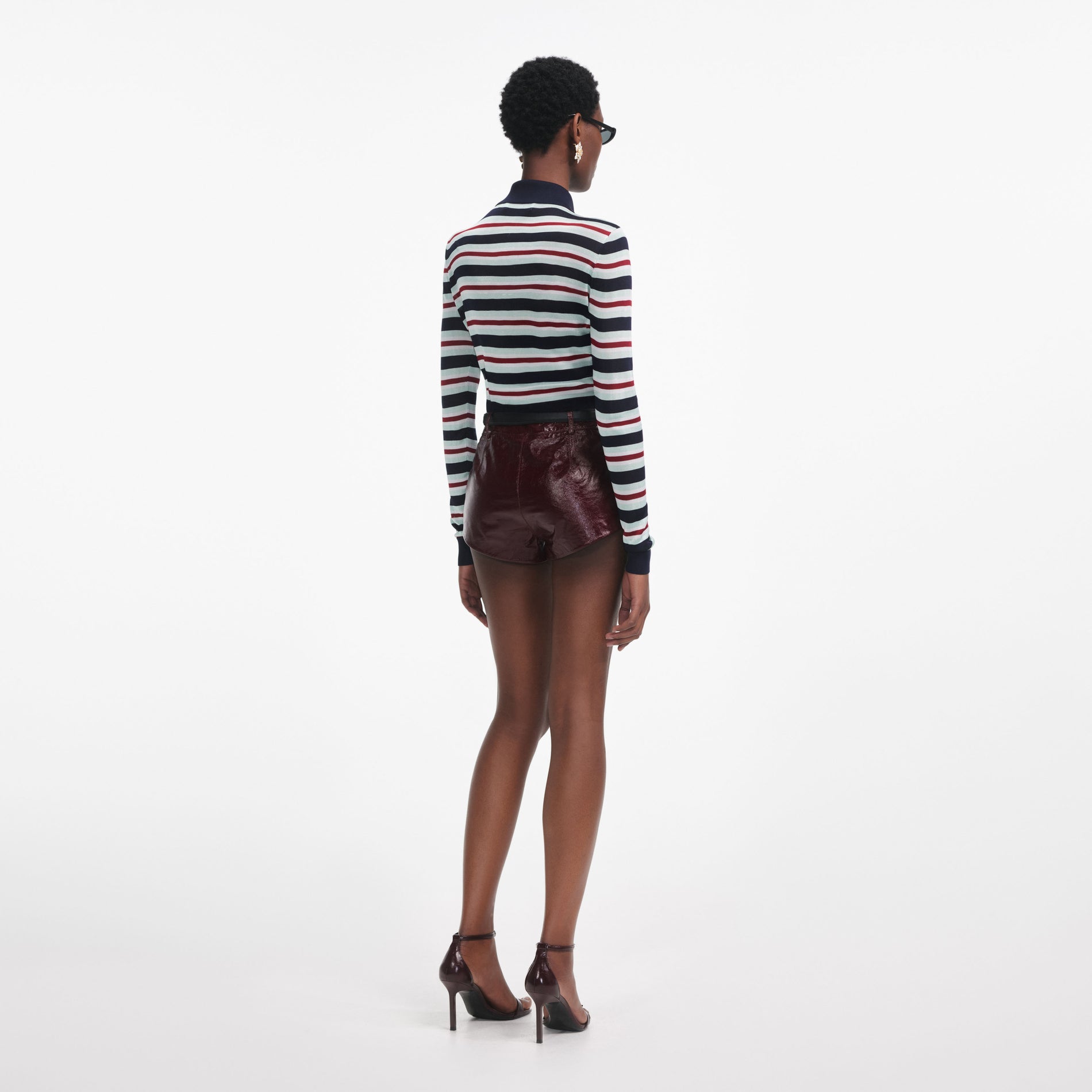 Back view of a woman wearing the Navy Striped Viscose Knit Top