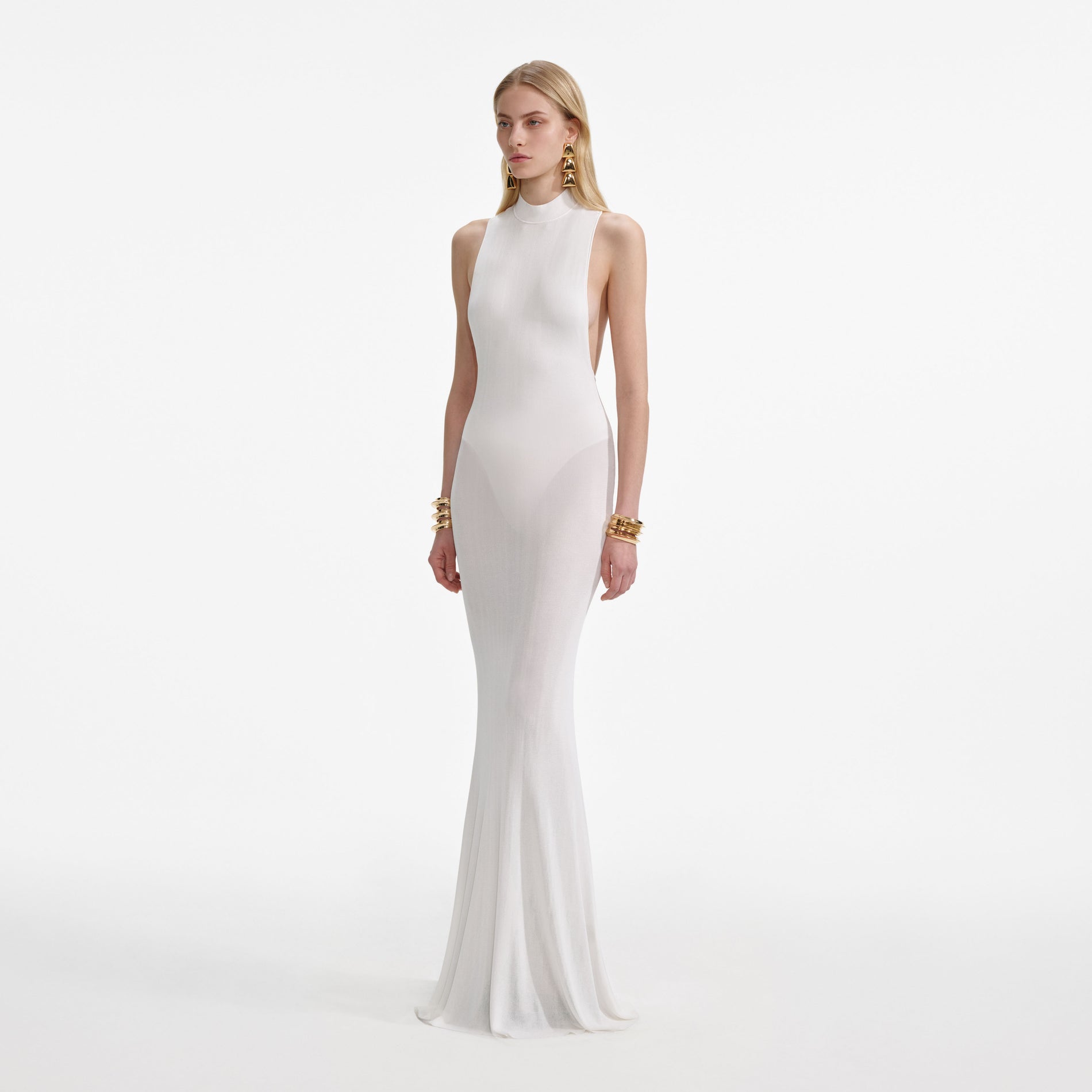 Side view of a woman wearing the White Racer Back Viscose Knit Maxi Dress