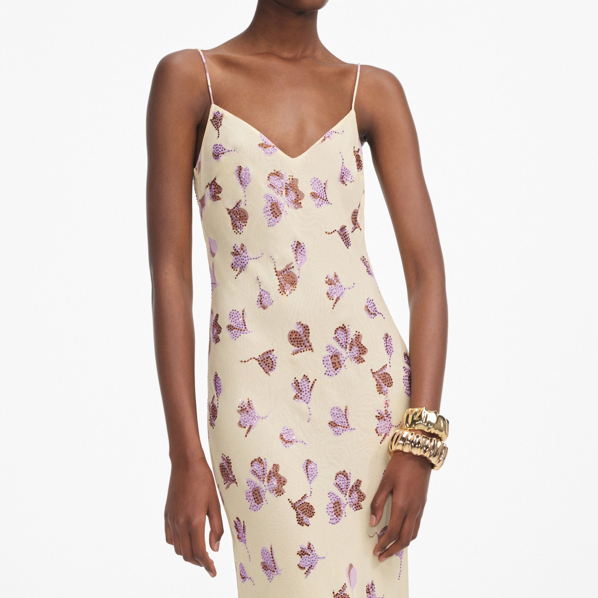 A close up of a woman wearing the Yellow Floral Rhinestone Maxi Dress