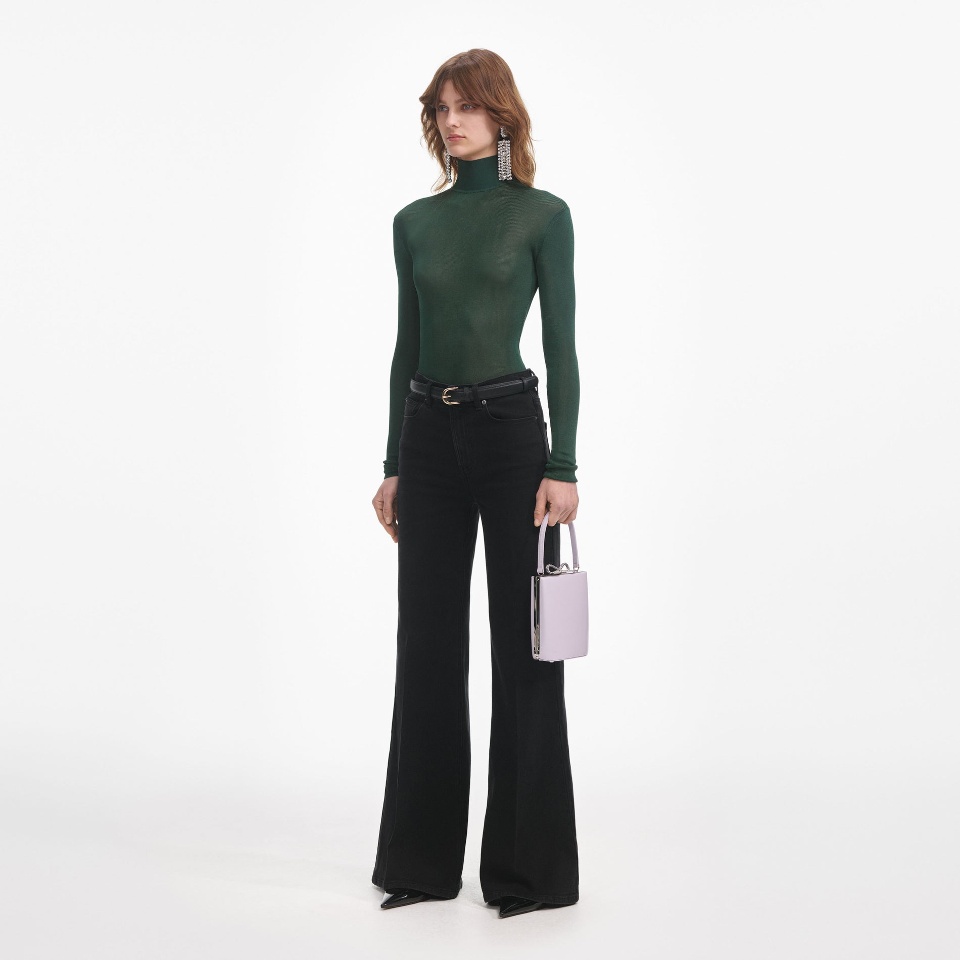 Side view of a woman wearing the Black Flared Jeans