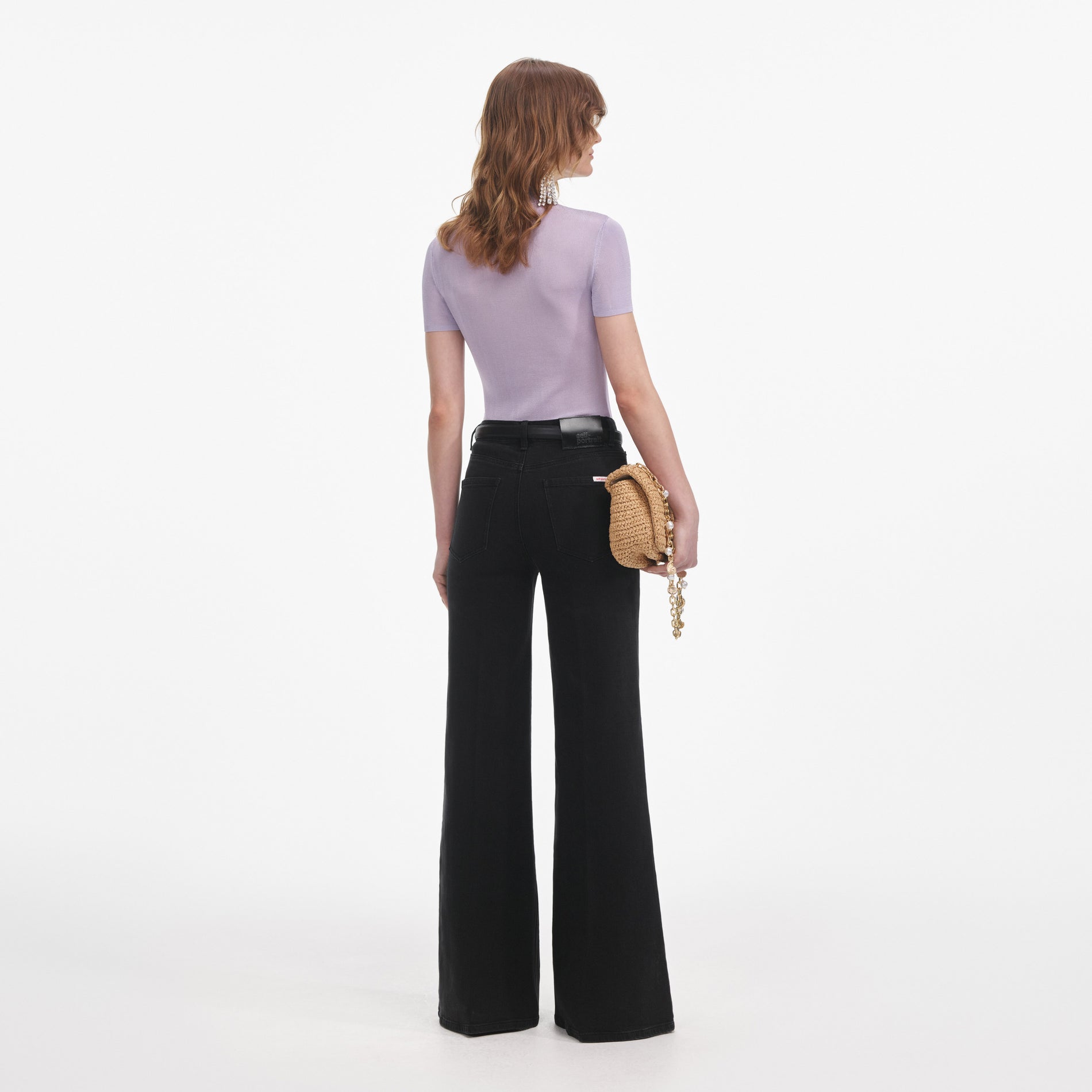 Back view of a woman wearing the Lilac Viscose Knit Short Sleeve Top