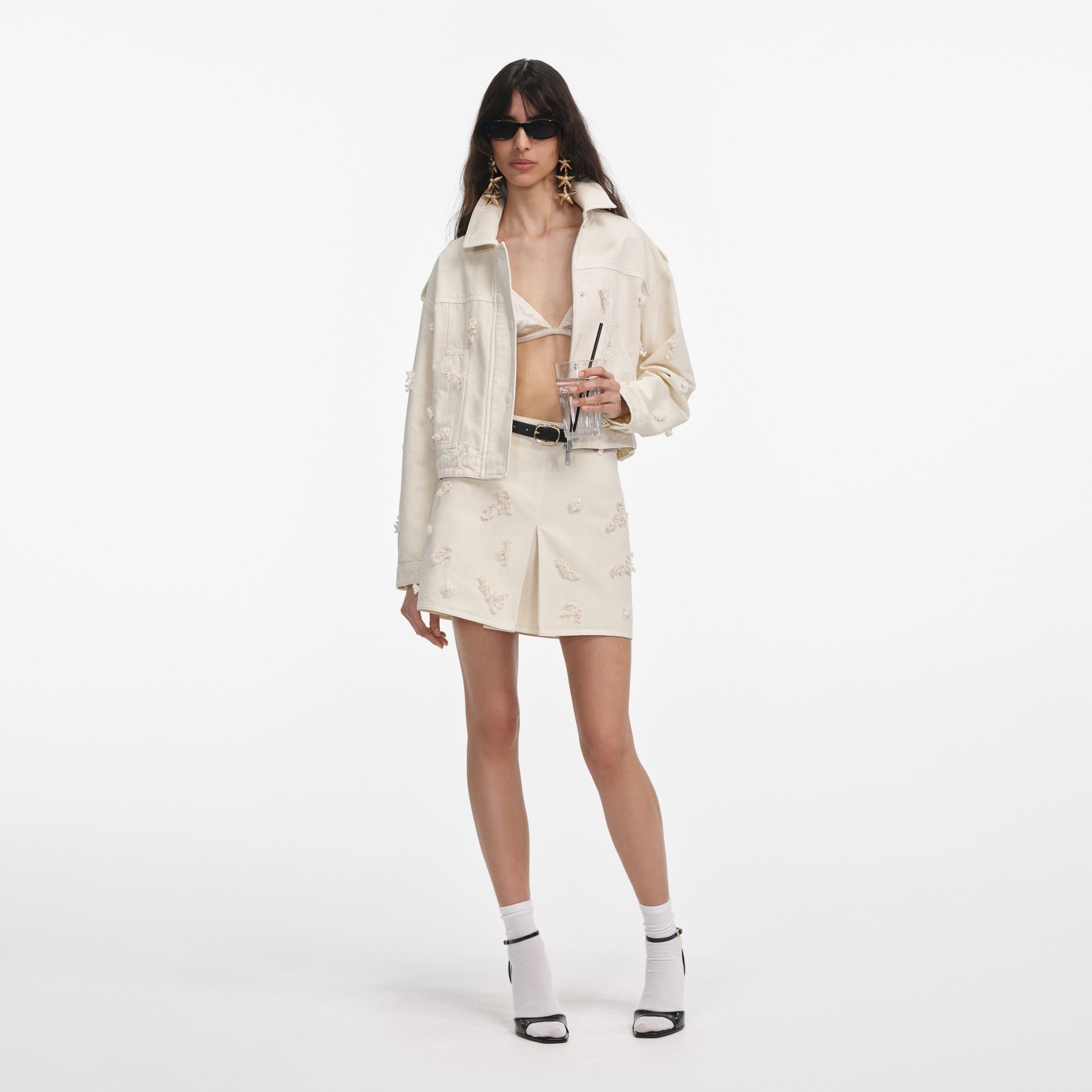 Front view of a woman wearing the Cream Denim Beaded Floral Jacket