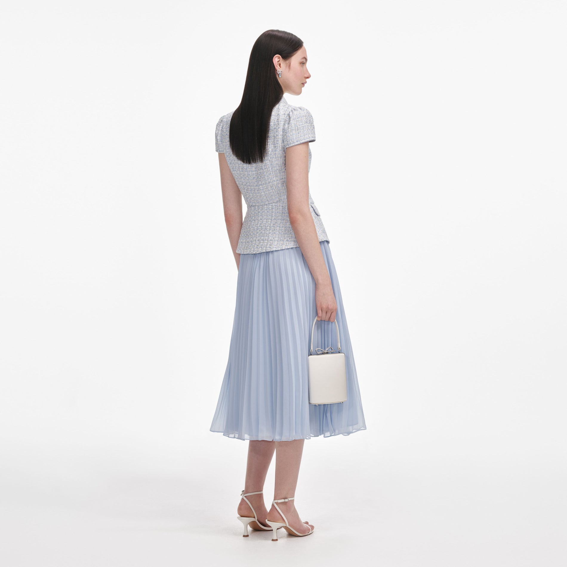 Back view of a woman wearing the Blue Boucle Bow Midi Dress