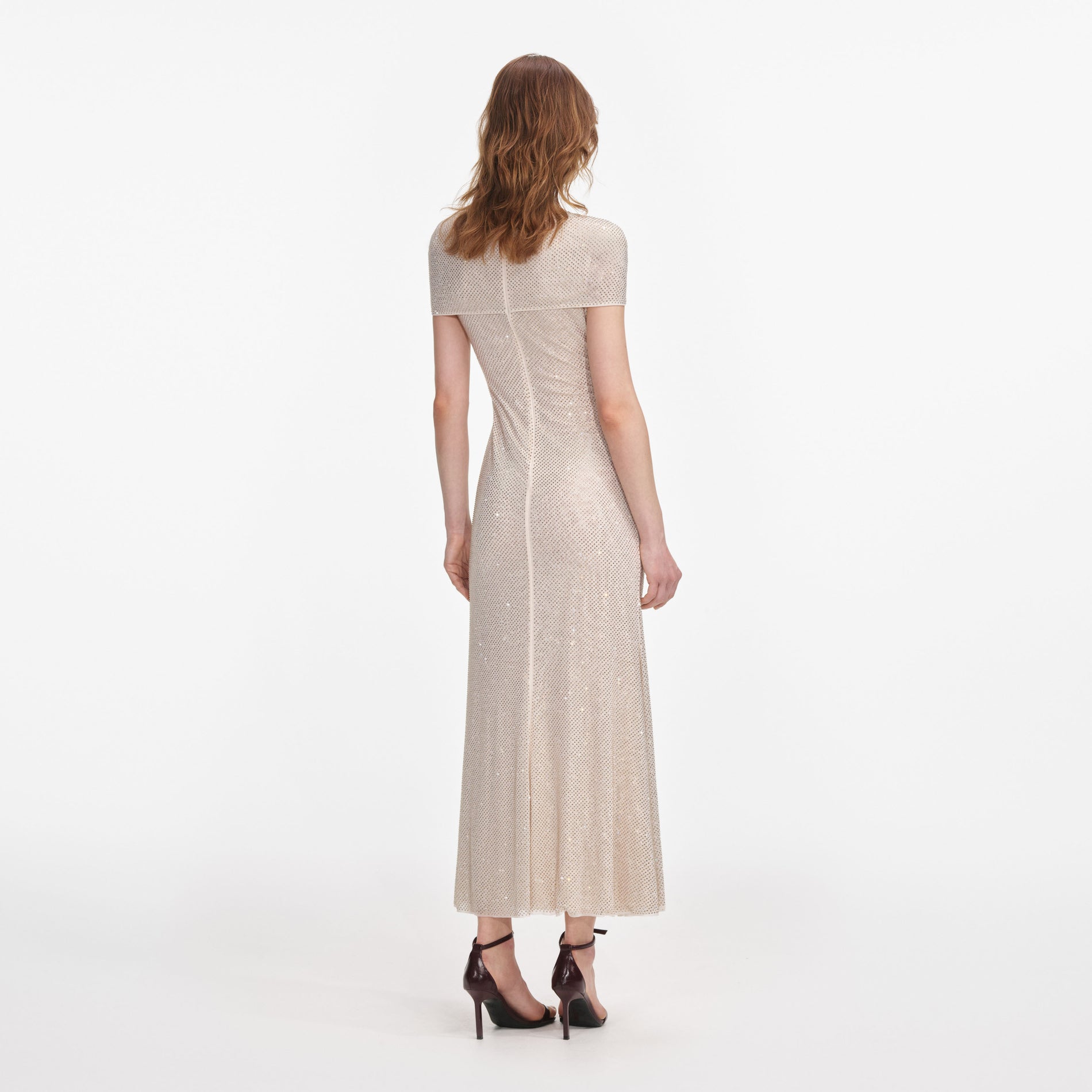 Back view of a woman wearing the Champagne Rhinestone Mesh Cut Out Midi Dress