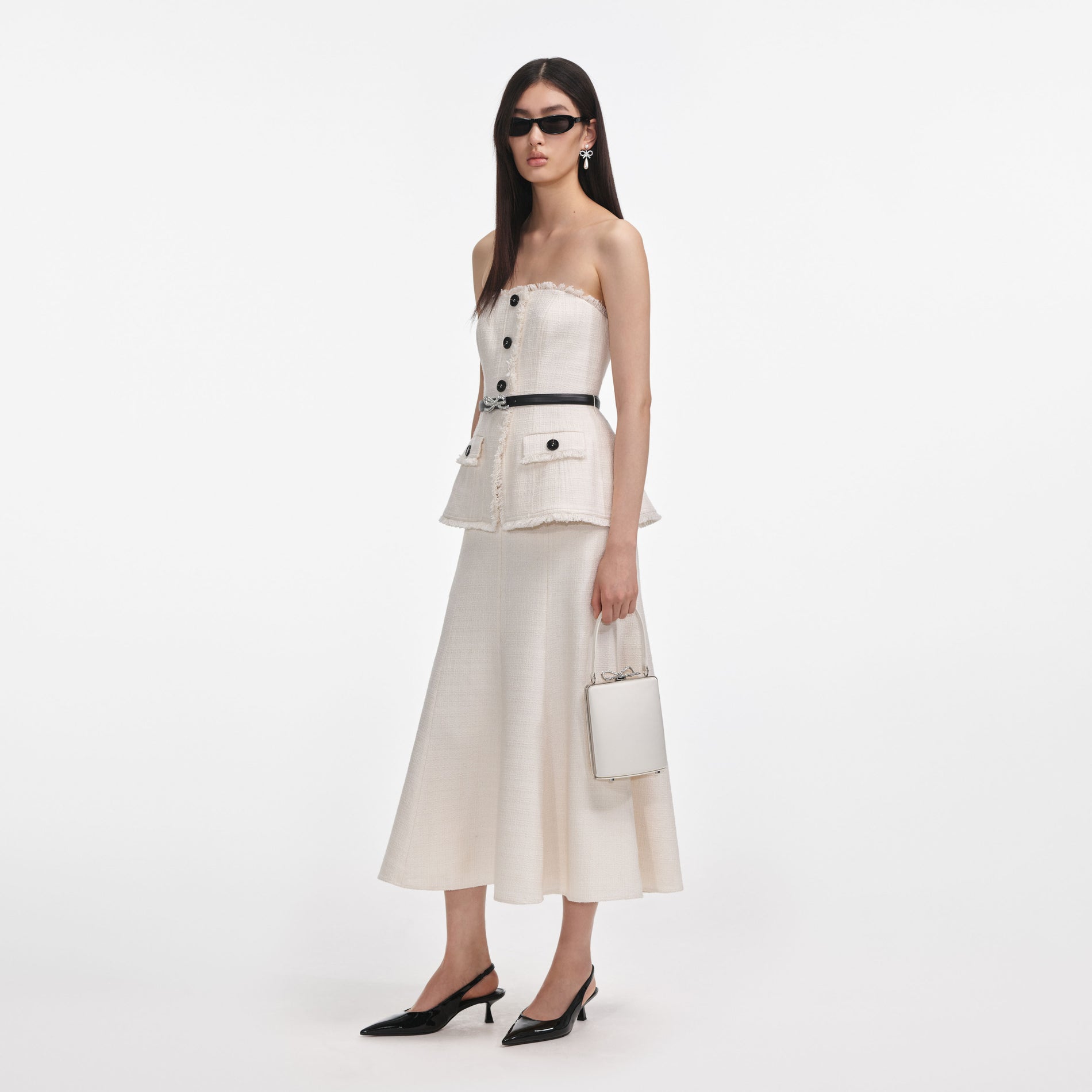 Side view of a woman wearing the Cream Boucle Bandeau Midi Dress