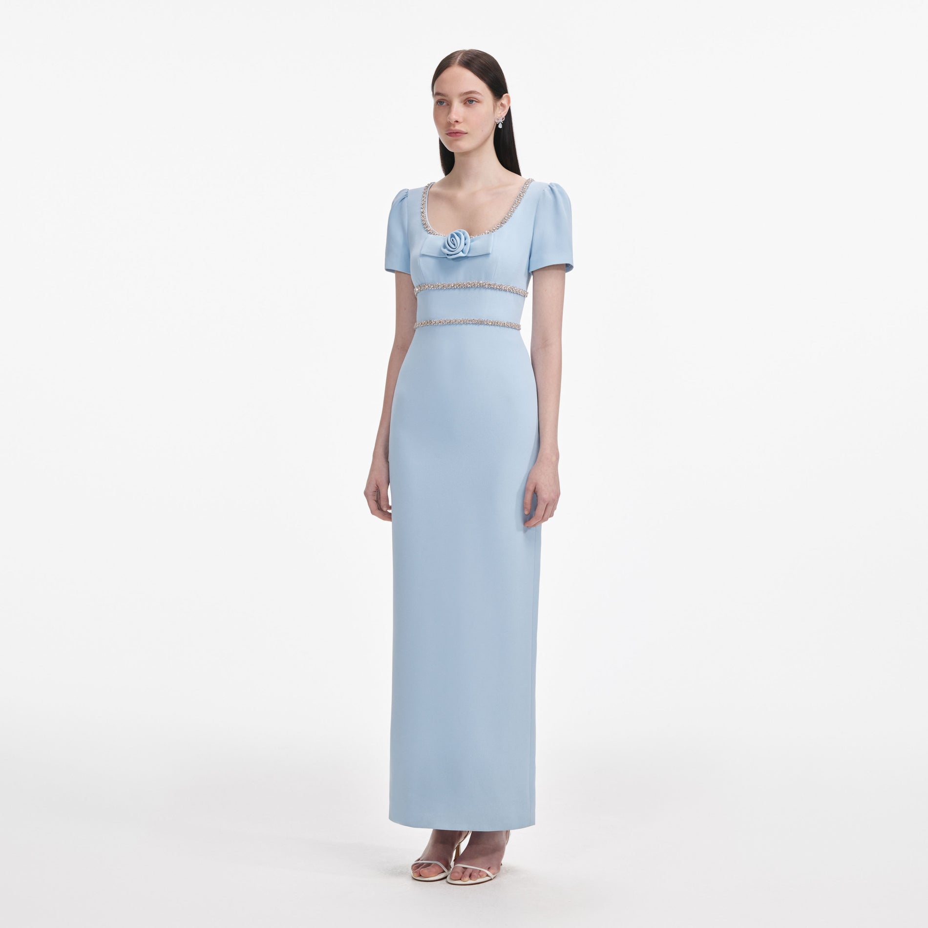 Side view of a woman wearing the Blue Crepe Crystal Trim Maxi Dress