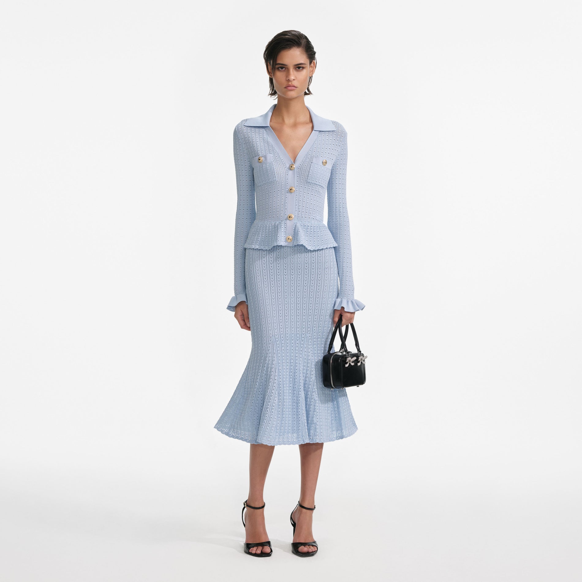 Front view of a woman wearing the Blue Pointelle Knit Midi Dress