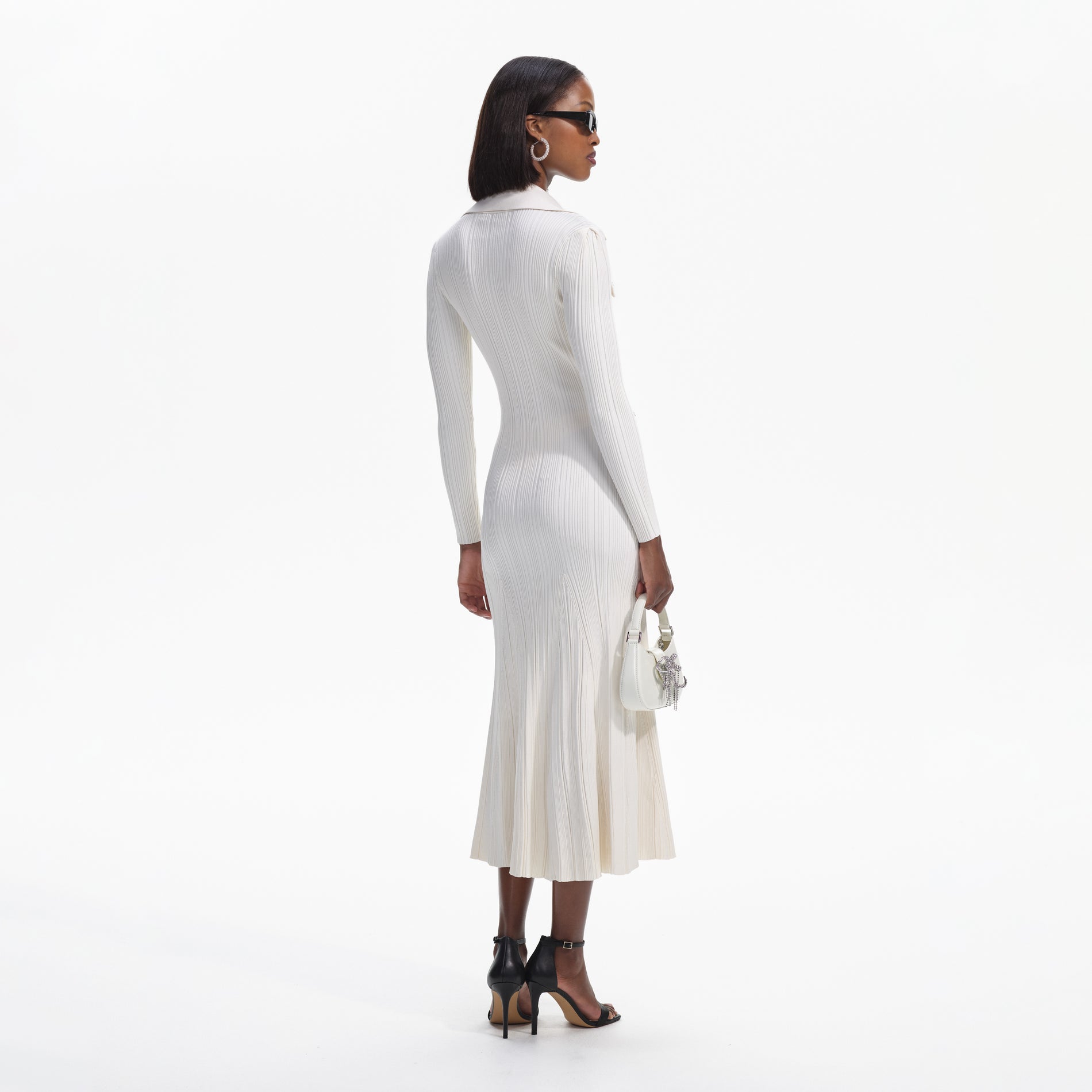 Back view of a woman wearing the Cream Knit Midi Dress