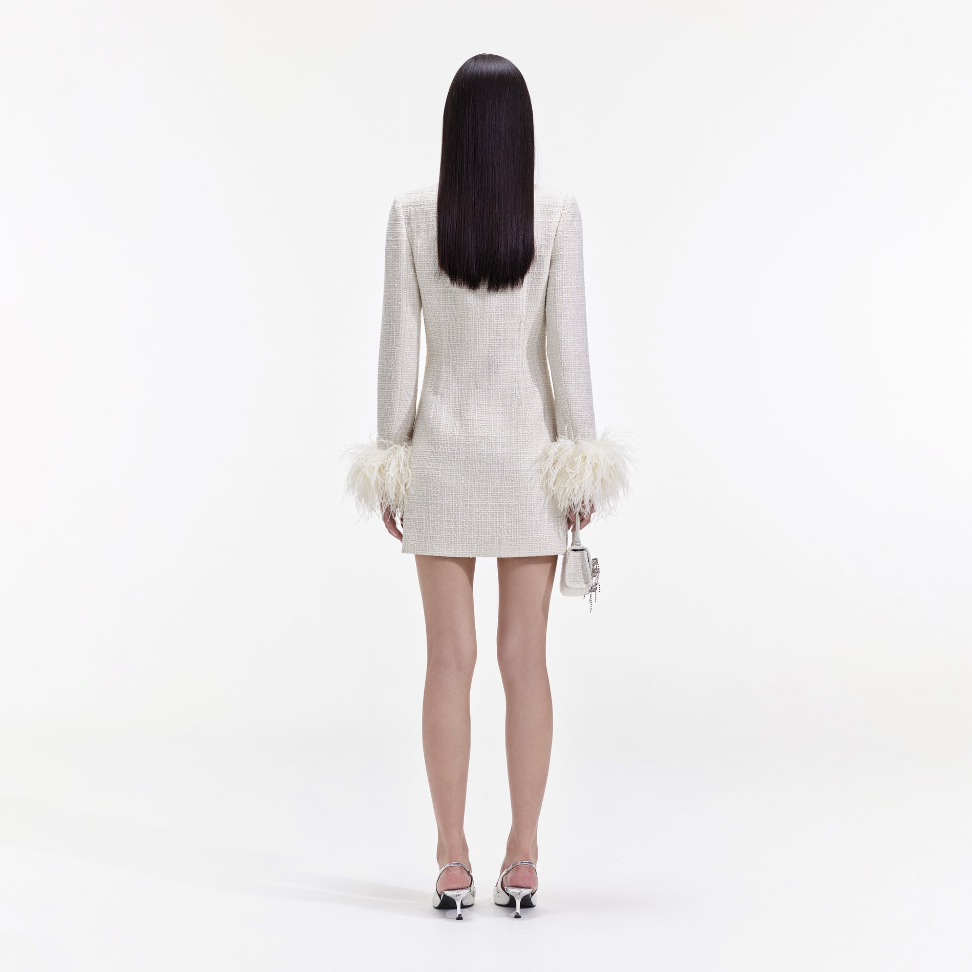 Back view of a woman wearing the Cream Boucle Feather Mini Dress