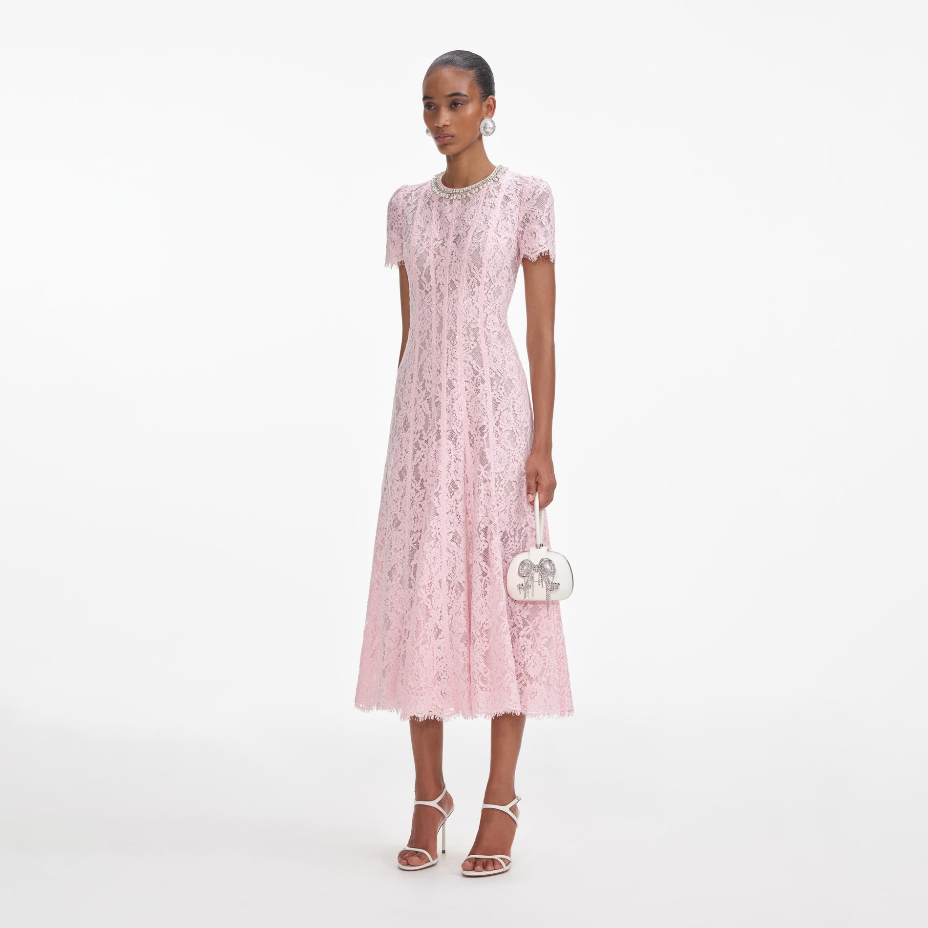 Side view of a woman wearing the Pink Lace Embellished Midi Dress
