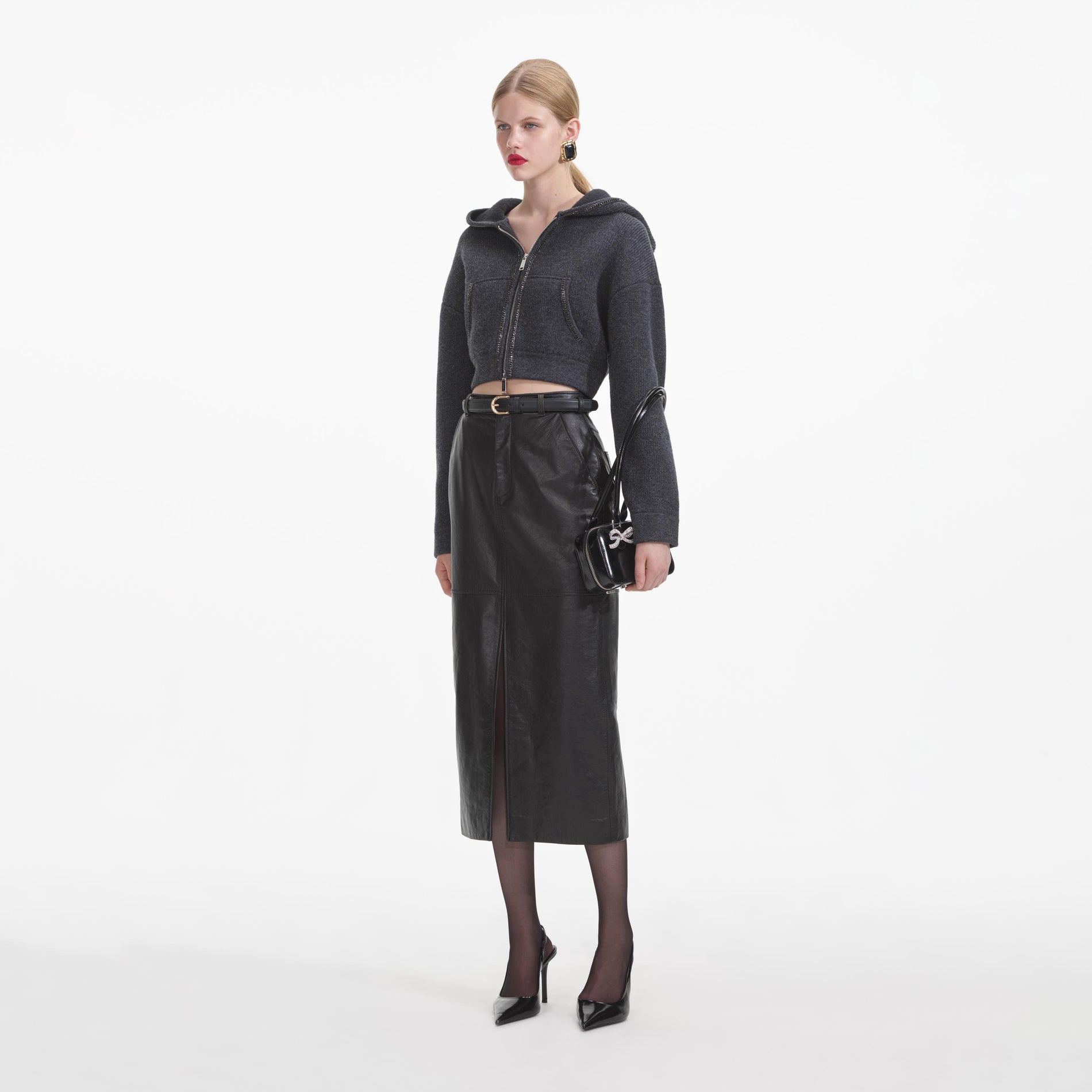 Side view of a woman wearing the Grey Knit Cropped Hoodie