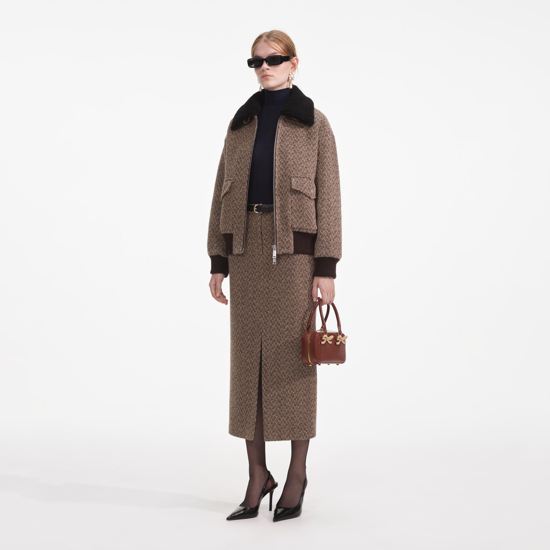 Side view of a woman wearing the Brown Herringbone Midi Skirt