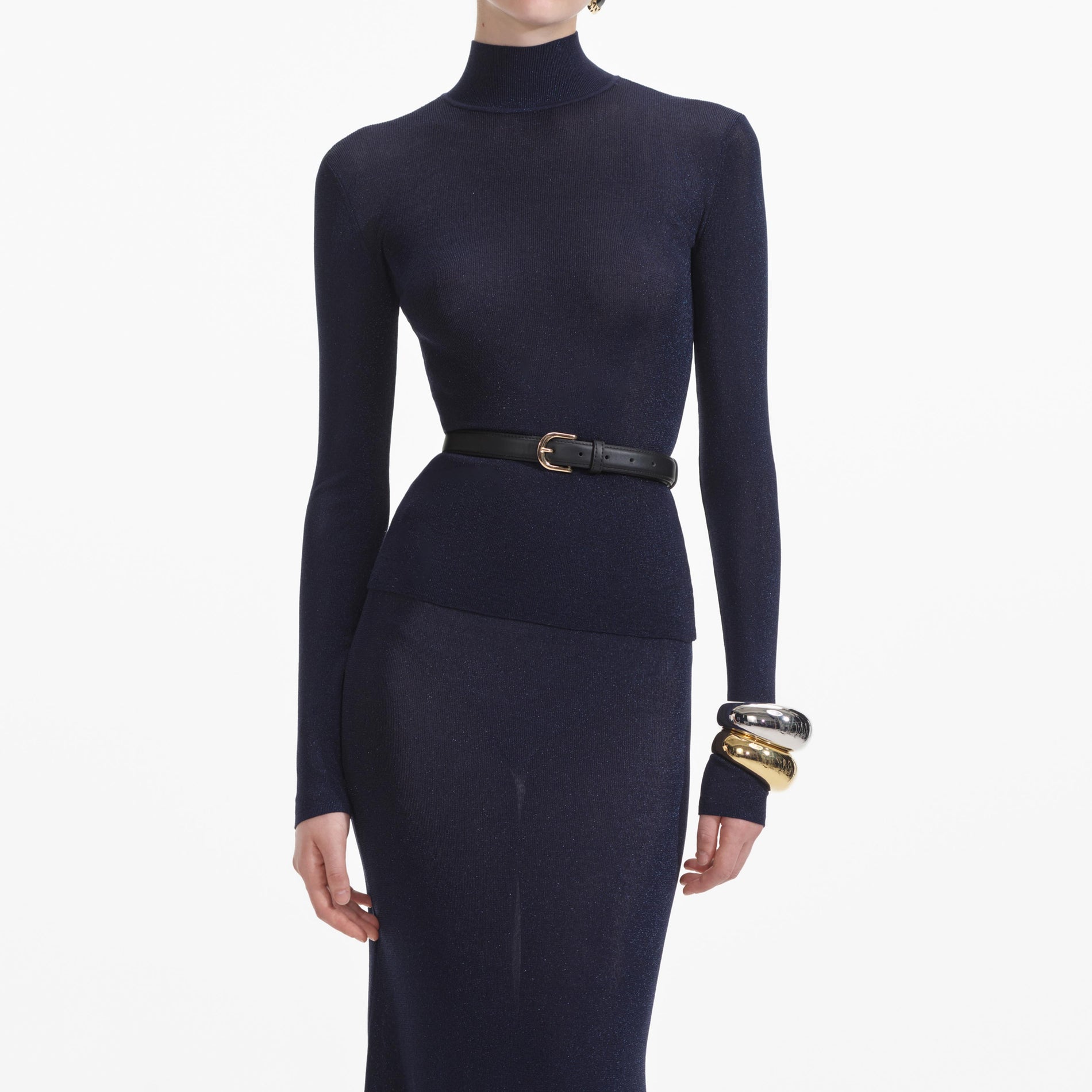 A close up of a woman wearing the Navy Viscose Knit Maxi Skirt