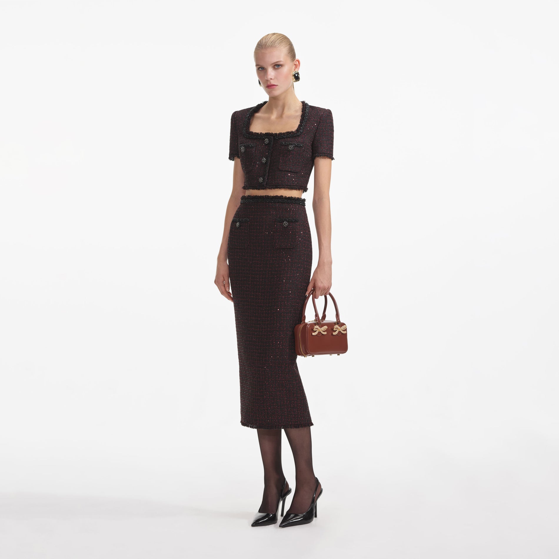 Side view of a woman wearing the Black Metallic Boucle Top