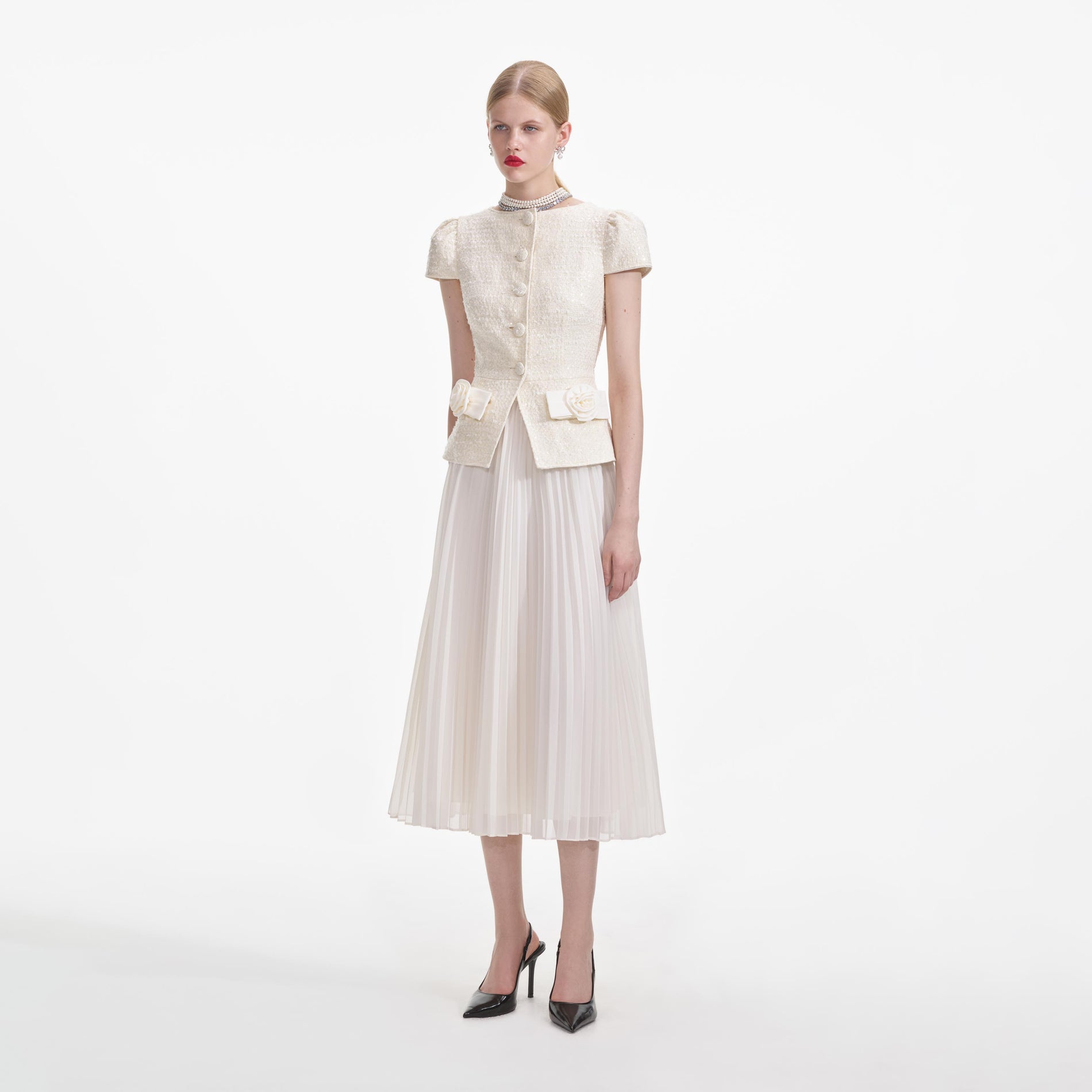 Side view of a woman wearing the Cream Boucle Bow Detail Midi Dress