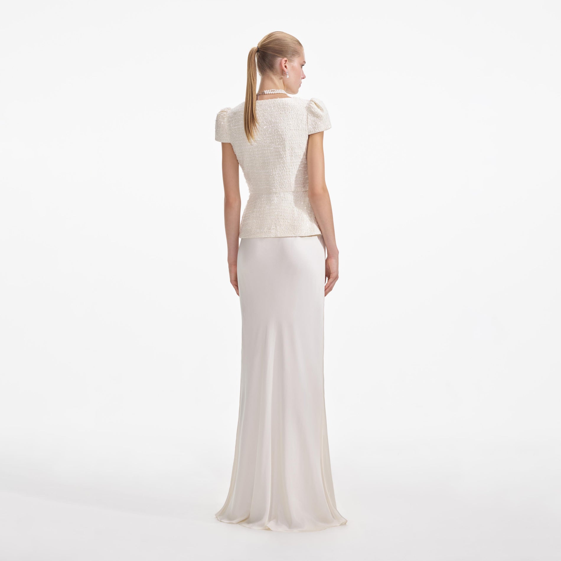 Back view of a woman wearing the Cream Boucle Bow Detail Maxi Dress