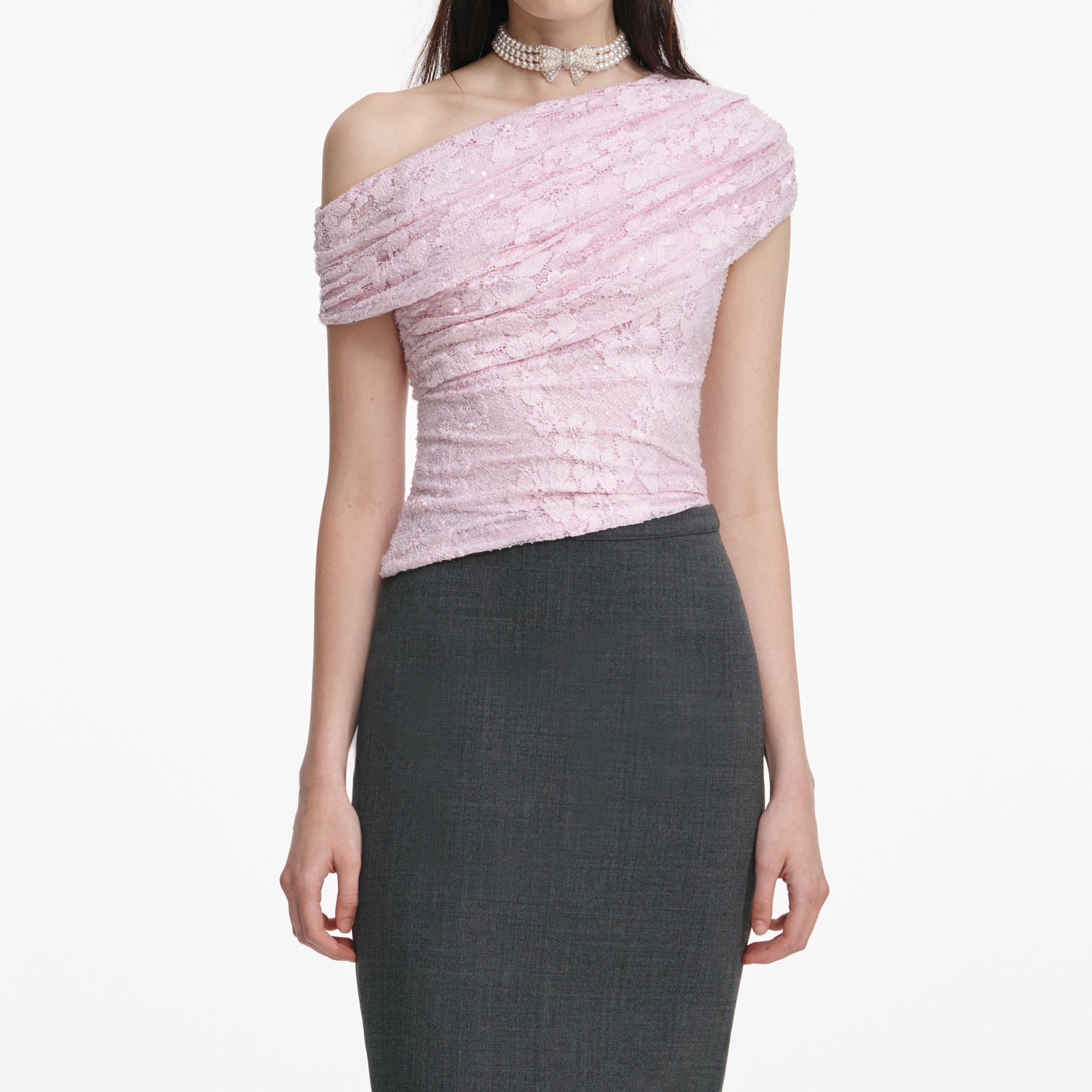 A close up of a woman wearing the Pink Rhinestone Lace Drape Top