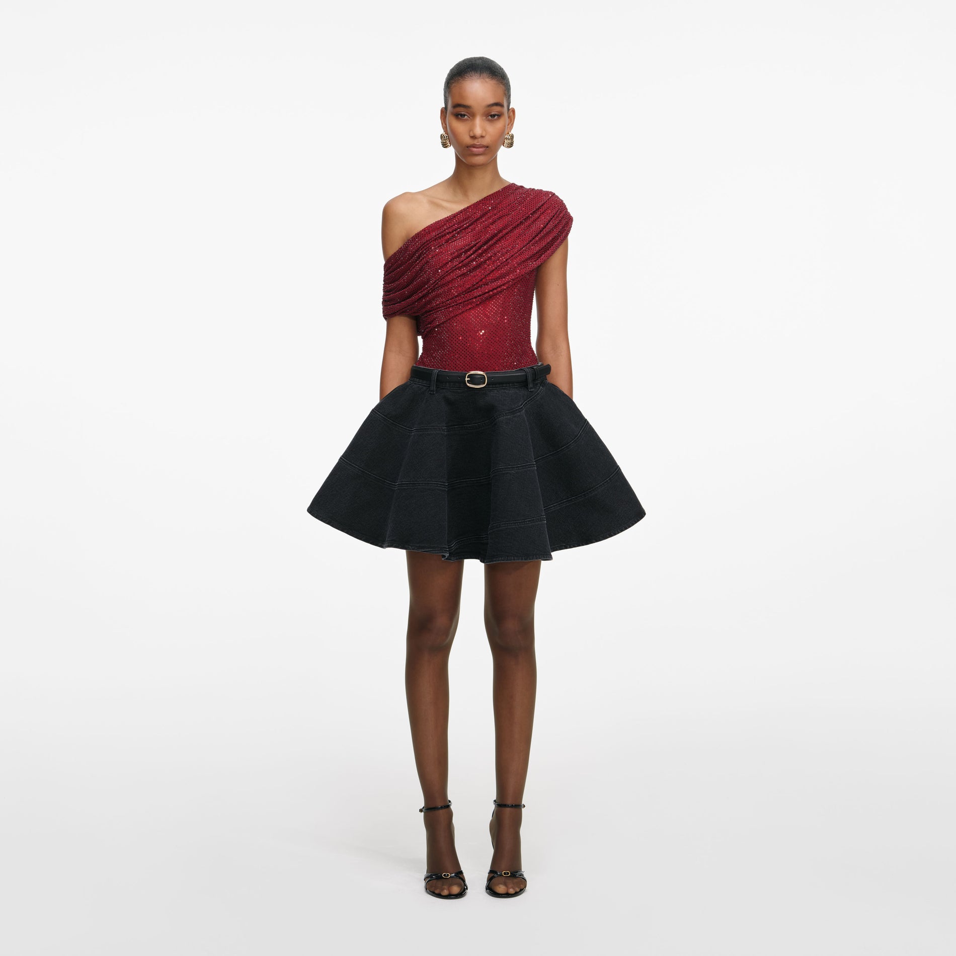 Front view of a woman wearing the Black Flared Denim Mini Skirt