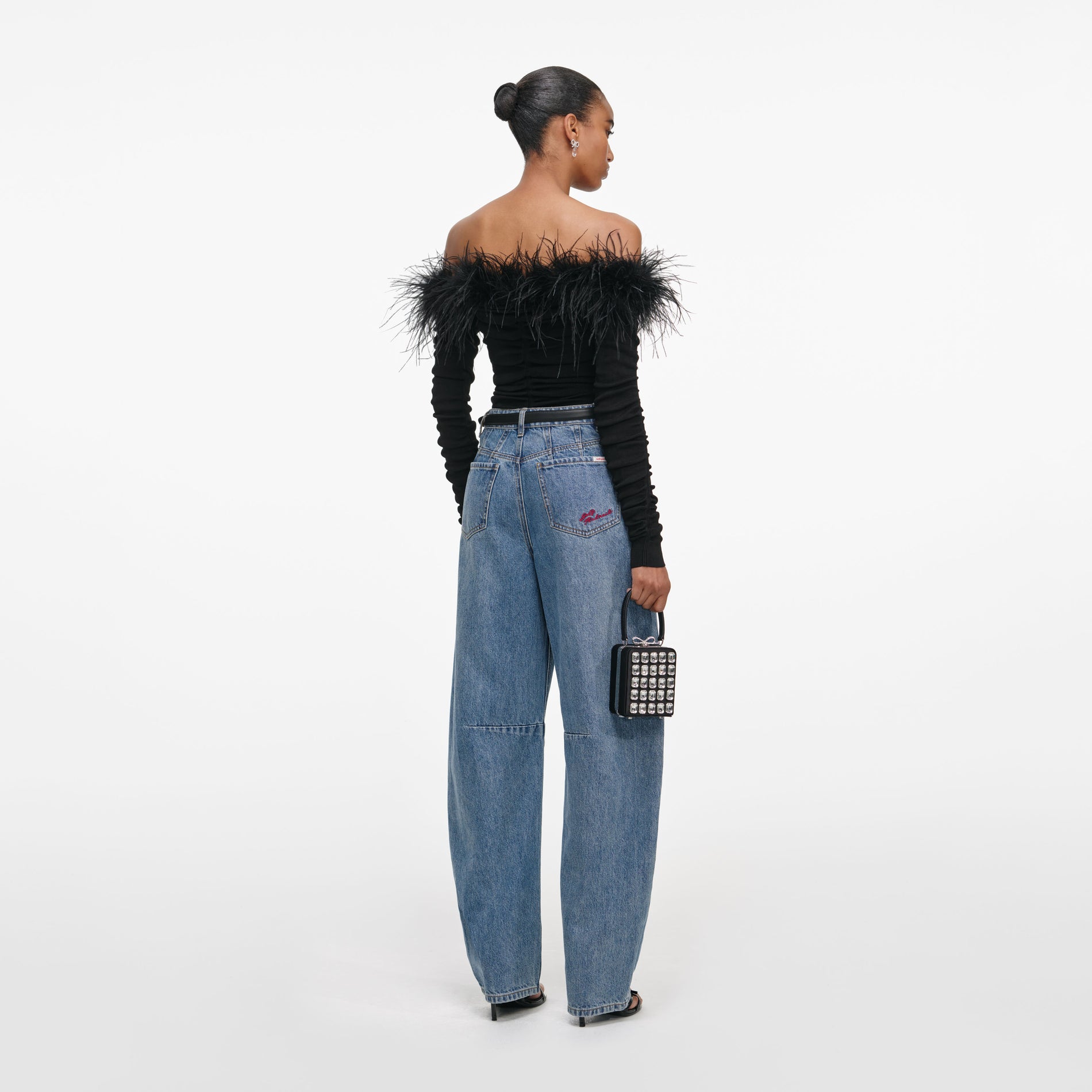 Back view of a woman wearing the Black Feather Viscose Knit Top